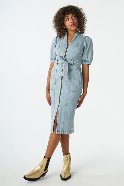 Scamp and Dude Heavy Washed Zip Detail Denim Dress | Model with curly hair wearing light wash denim dress with gold boots