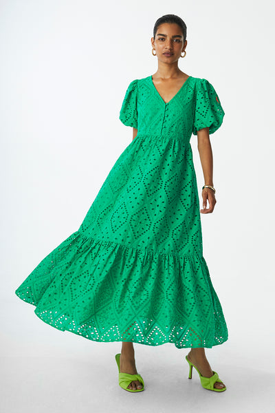 Scamp and Dude Green Broderie Anglaise Midi Dress | Image of model wearing green midi dress with green heels against white background