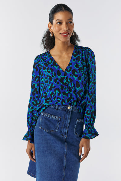 Scamp and Dude Blue, Green and Black Leopard Print Long-Sleeve Blouse | Model wearing a blue and black leopard print shirt with denim skirt