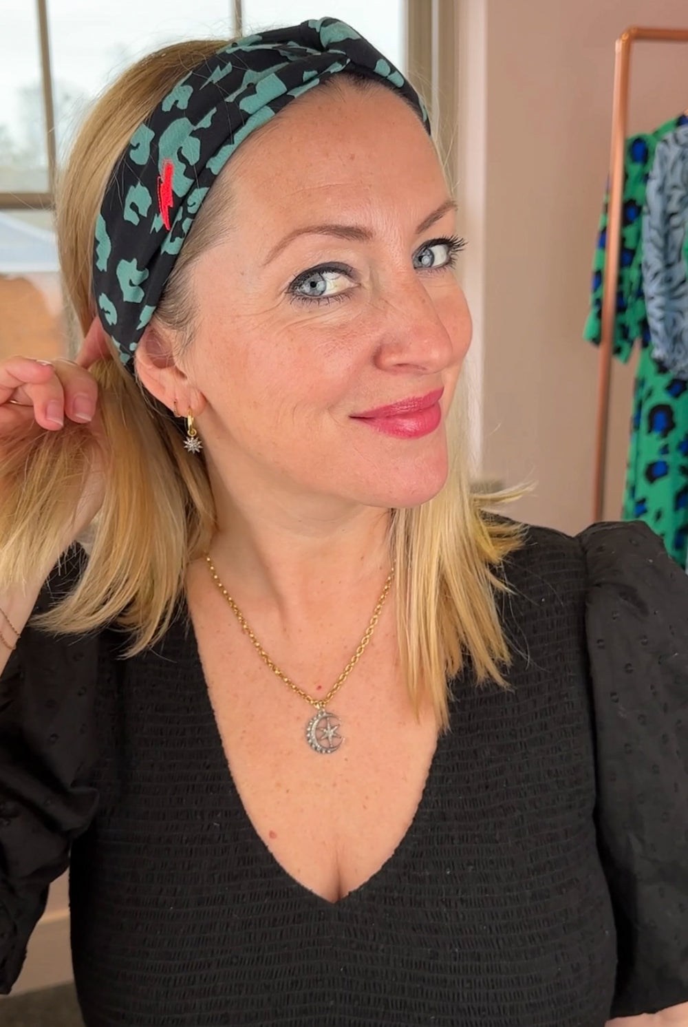 Jo wearing a black with khaki leopard and lightning bolt print headband