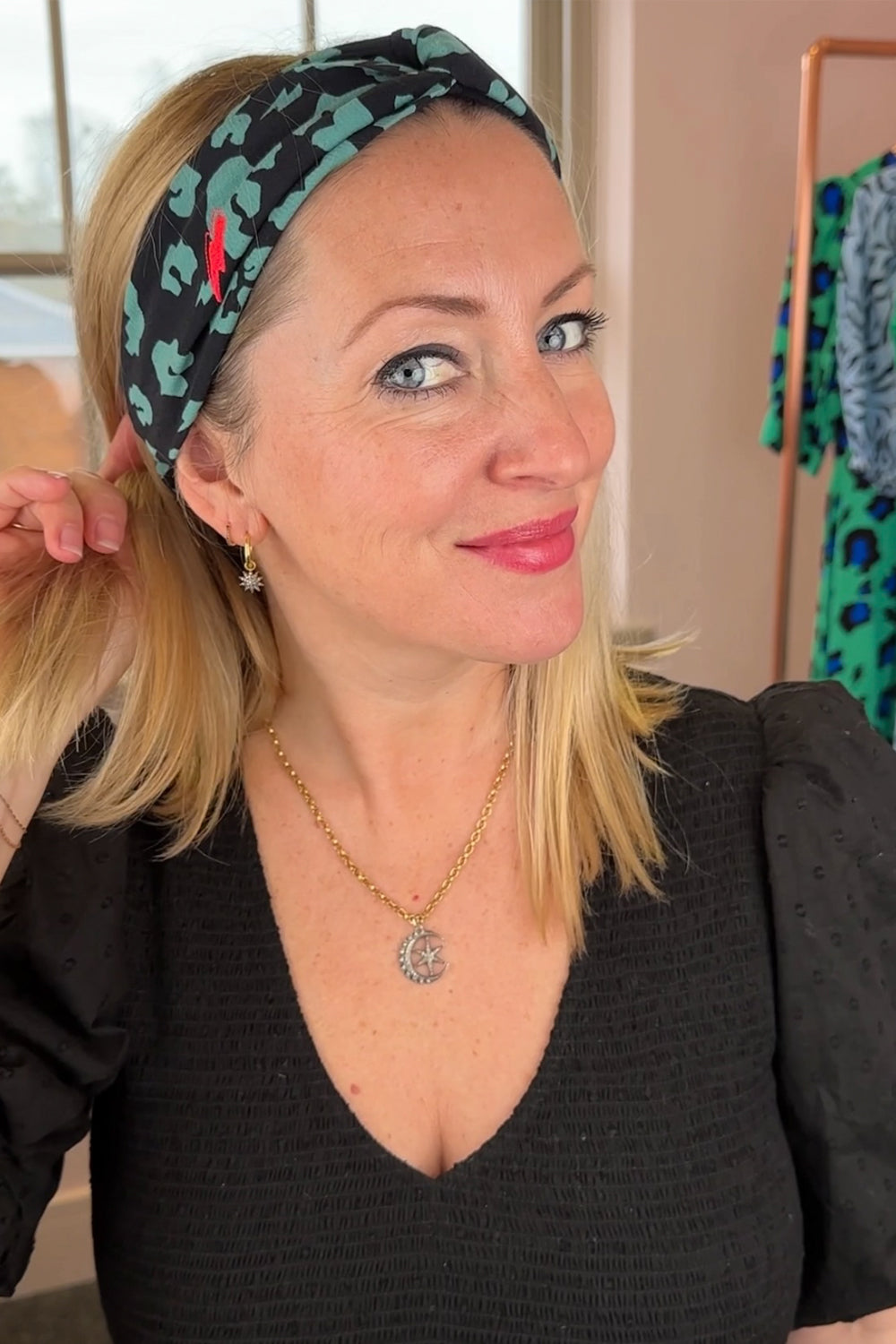 Jo wearing a black with khaki leopard and lightning bolt print headband