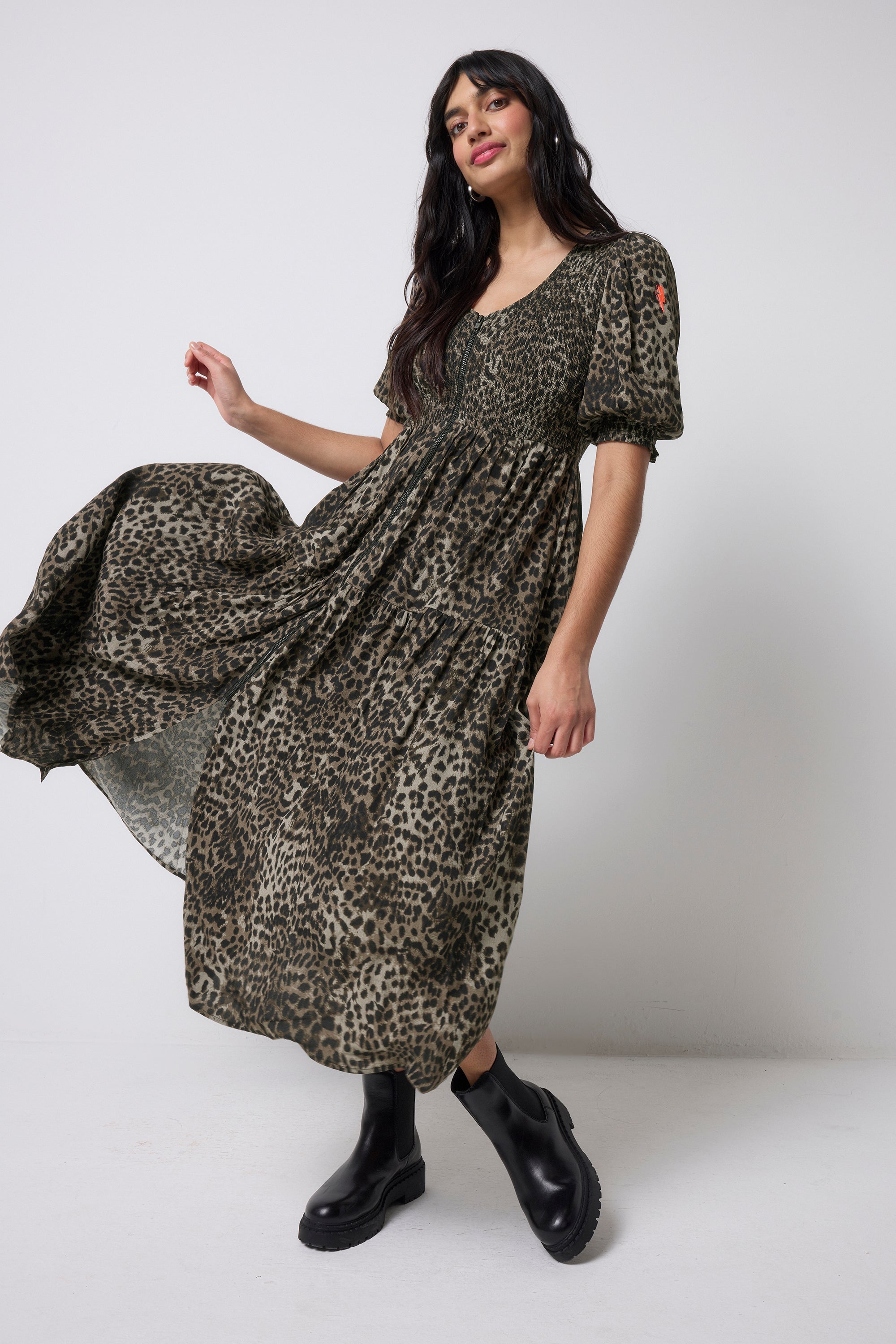 Scamp and Dude Khaki Cheetah Shirred Zip Detail Midi Dress | Model wearing a khaki shirred zip front midi dress in a cheetah print with chunky black boots.