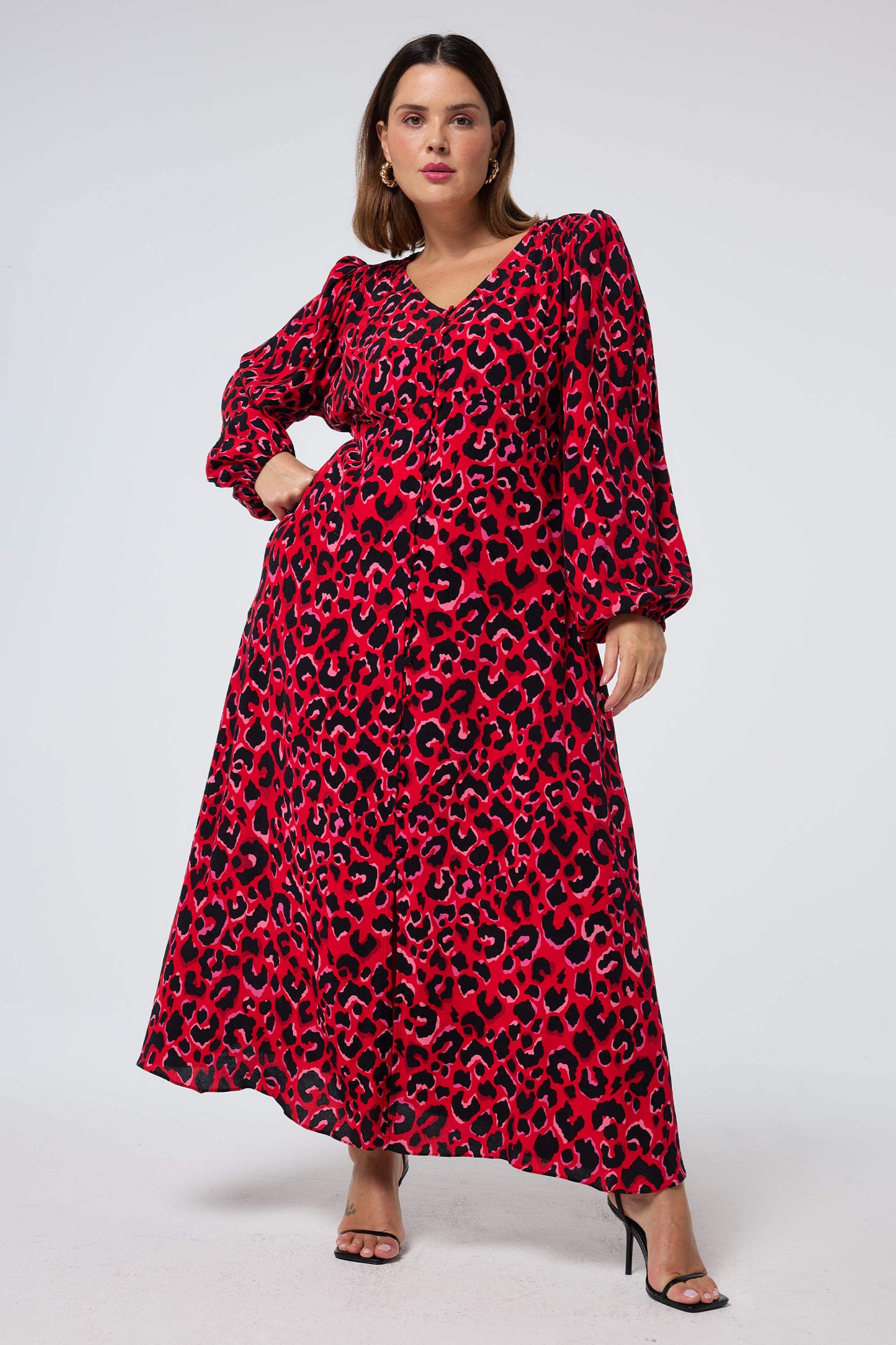 Scamp and Dude Red with Pink and Black Pop Leopard Blouson Sleeve Godet Midi Dress | Model wearing a long sleeve red dress with leopard print, paired with black heels.