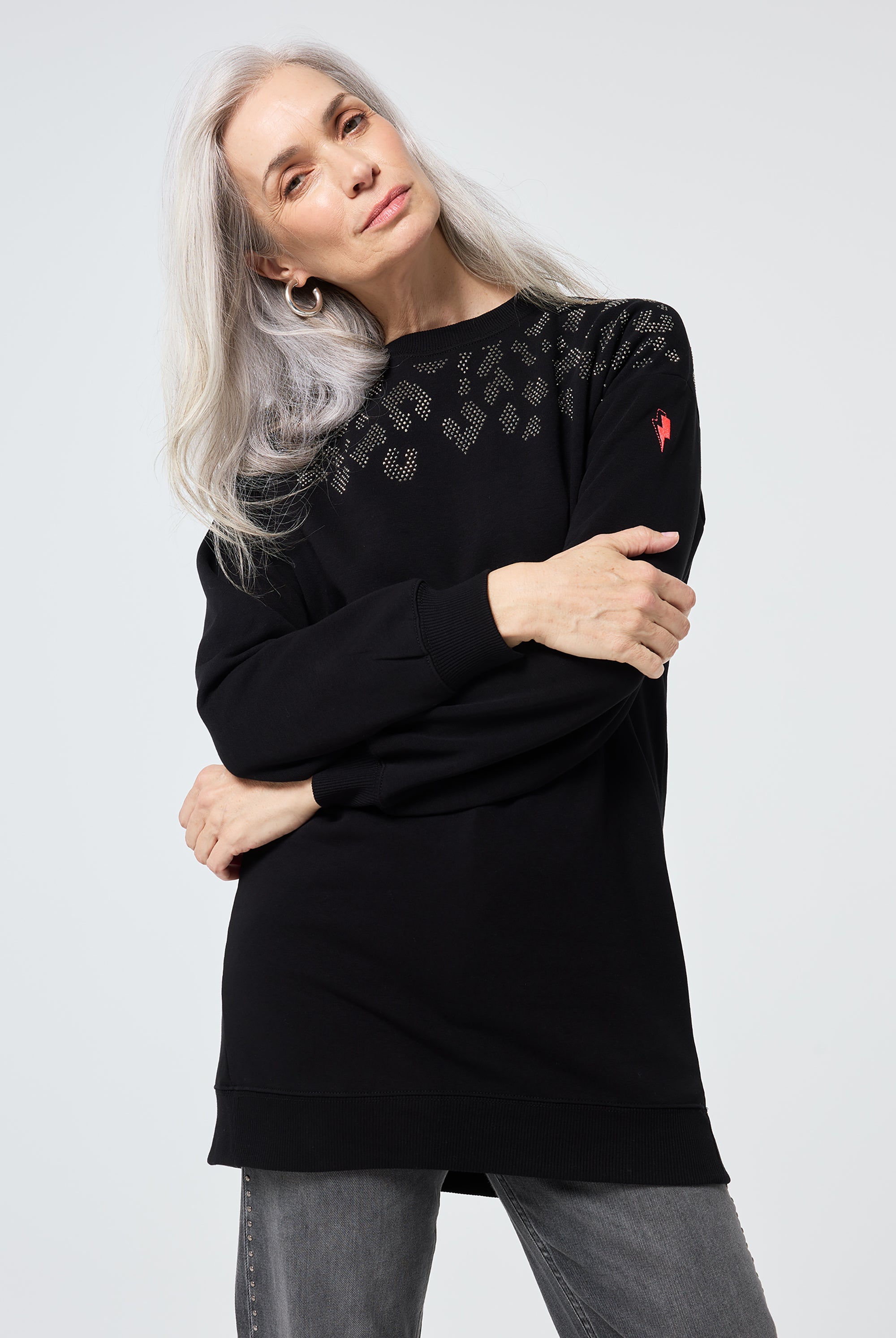 Scamp and Dude Black with Silver Studded Leopard Oversized Tunic | Model wearing a black tunic sweatshirt with grey jeans.
