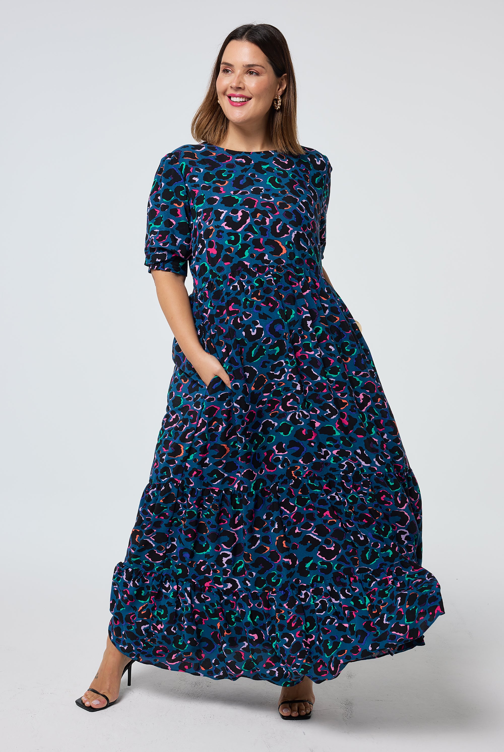 Scamp and Dude Teal with Rainbow Shadow Leopard Maxi Dress | Model wearing a teal short sleeve tiered maxi dress with rainbow shadow leopard print.