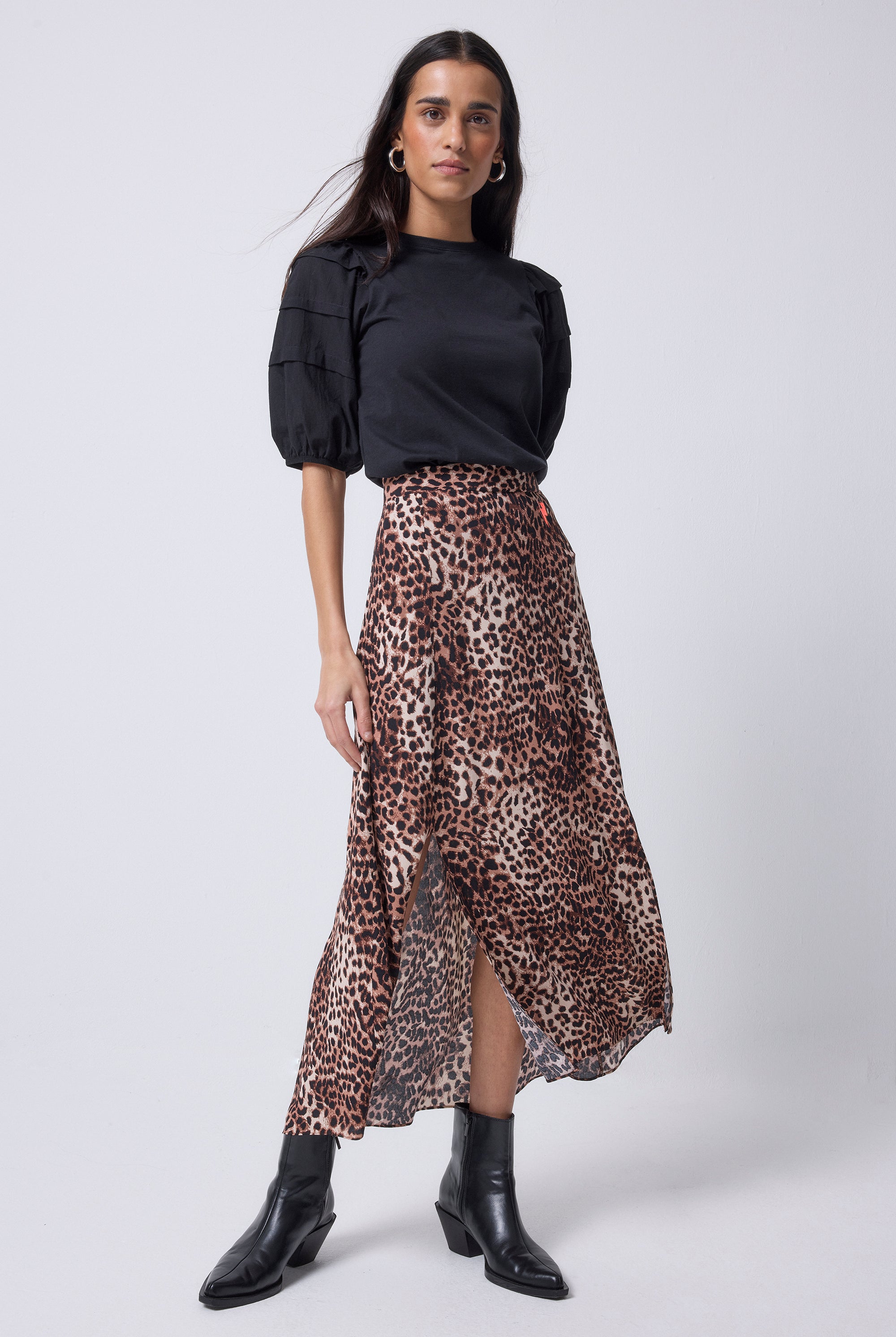 Scamp and Dude Neutral with Black Cheetah Split Front Skirt | Model wearing a black t-shirt and neutral cheetah print skirt with black boots.