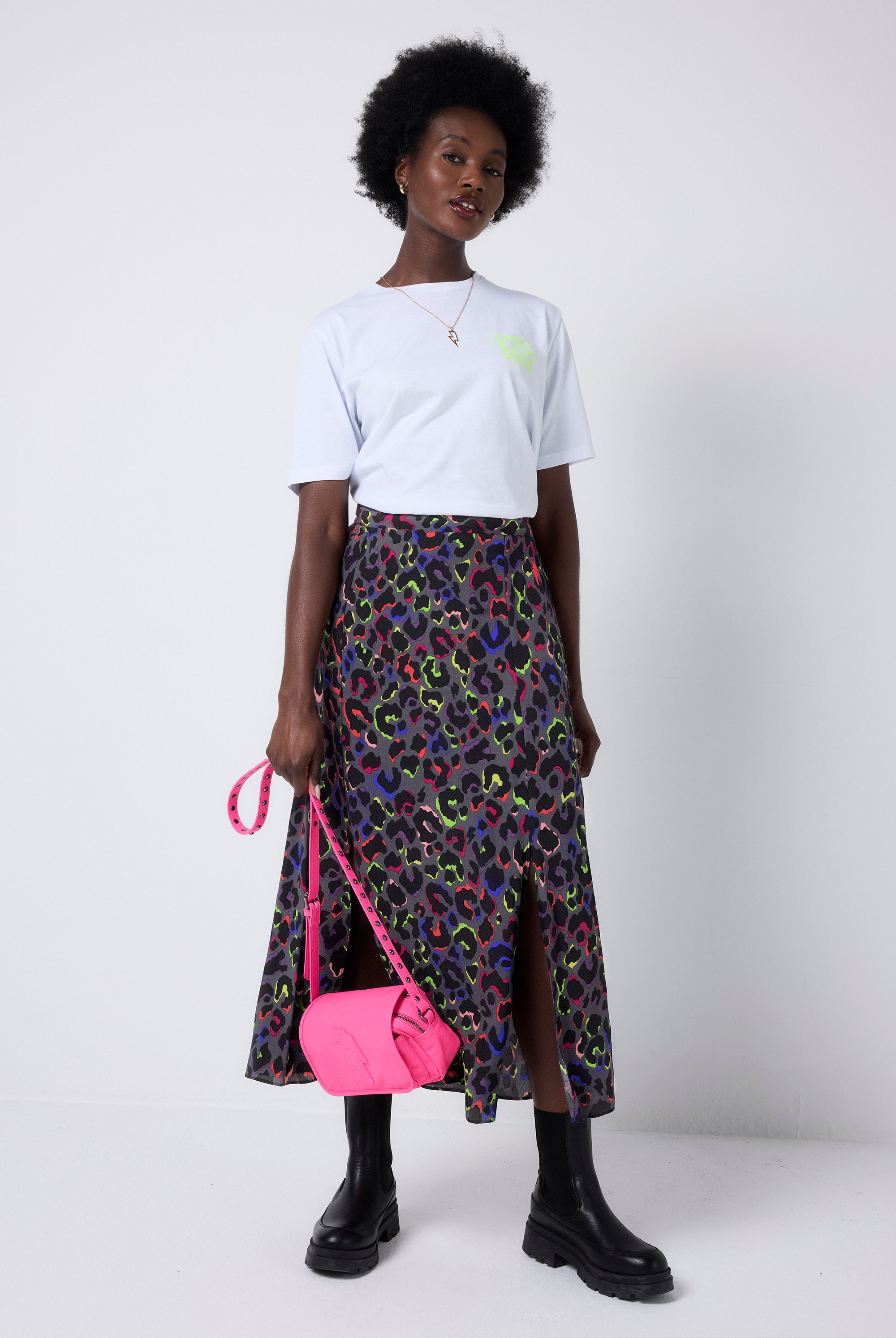 Scamp and Dude Grey with Rainbow Shadow Leopard Split Front Skirt | Model wearing a white t-shirt with a grey leopard print skirt featuring dark blue and neon pink and yellow leopard print.