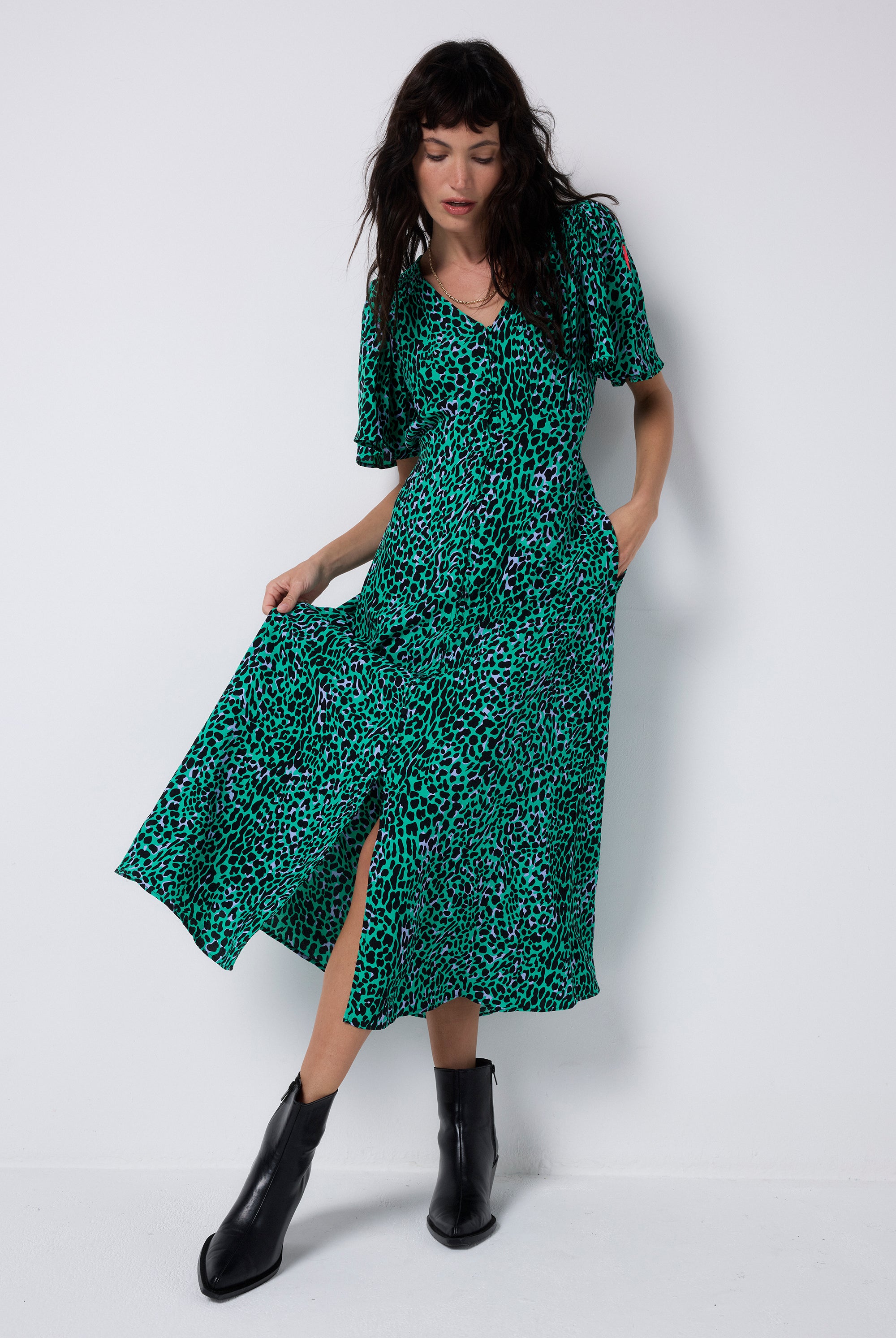 Scamp and Dude Green with Black Leopard Angel Sleeve Midi Tea Dress | Model wearing a green midi tea dress featuring a black leopard print and angel sleeves.