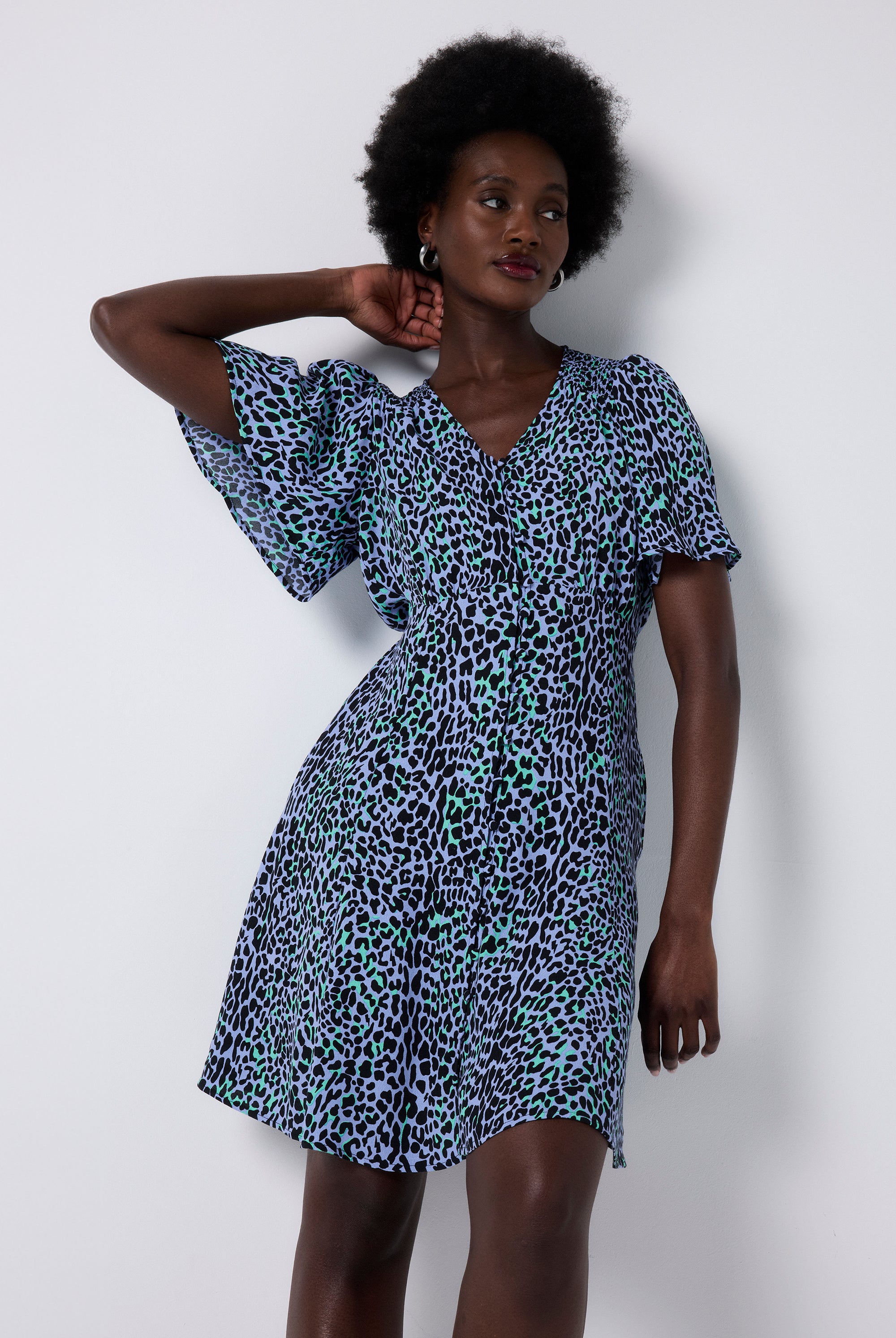 Scamp and Dude Blue with Black Leopard Angel Sleeve Short Tea Dress | Model wearing short tea dress with angel sleeves in a leopard print.