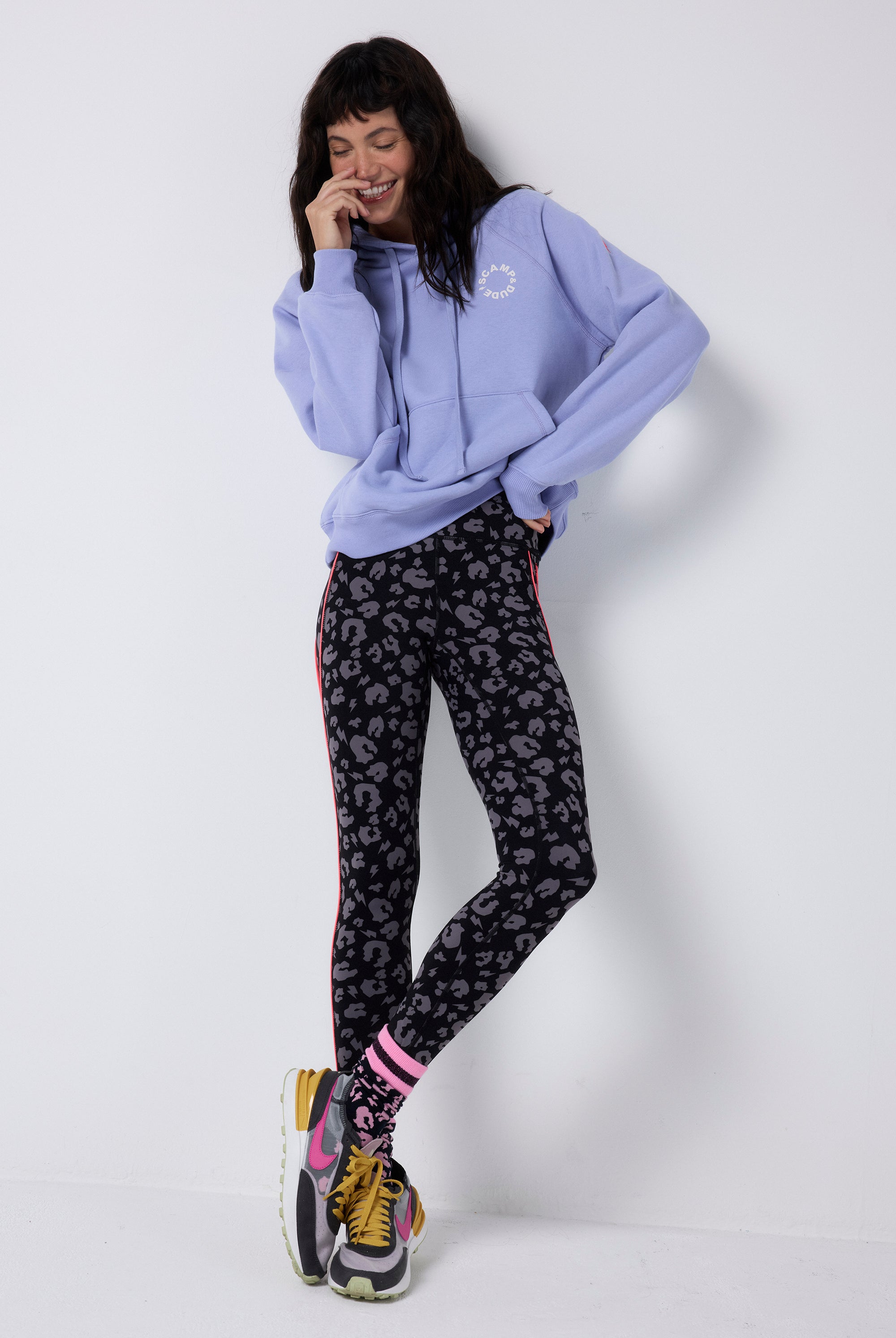 Scamp and Dude Black with Grey Leopard Full Length Active Leggings | Model wearing full length black active leggings featuring grey leopard print paired with a blue hoodie.