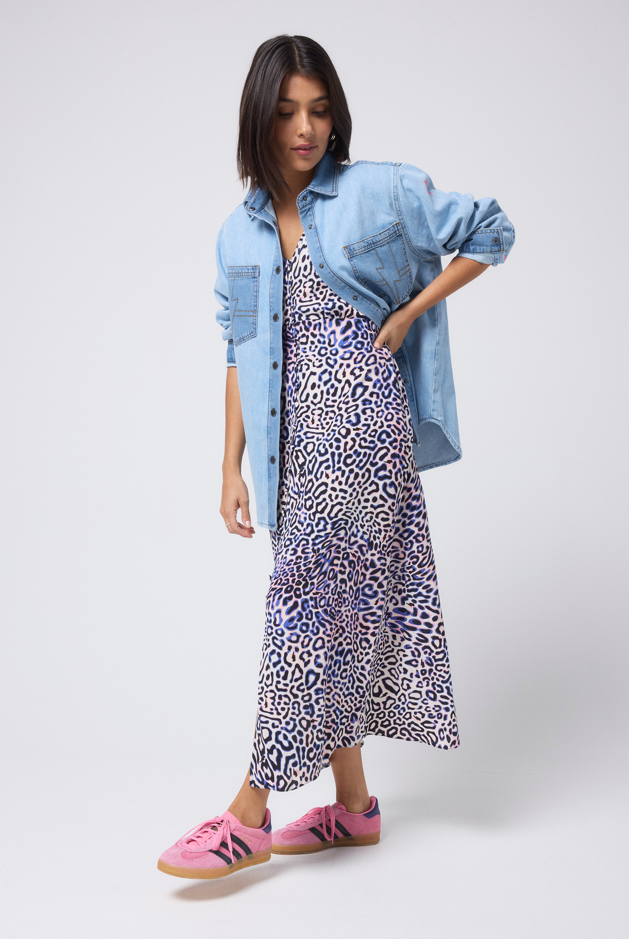 Scamp and Dude Pale Indigo Relaxed Denim Shirt | Model wearing an animal print dress with a mixed wash pale blue denim shirt.