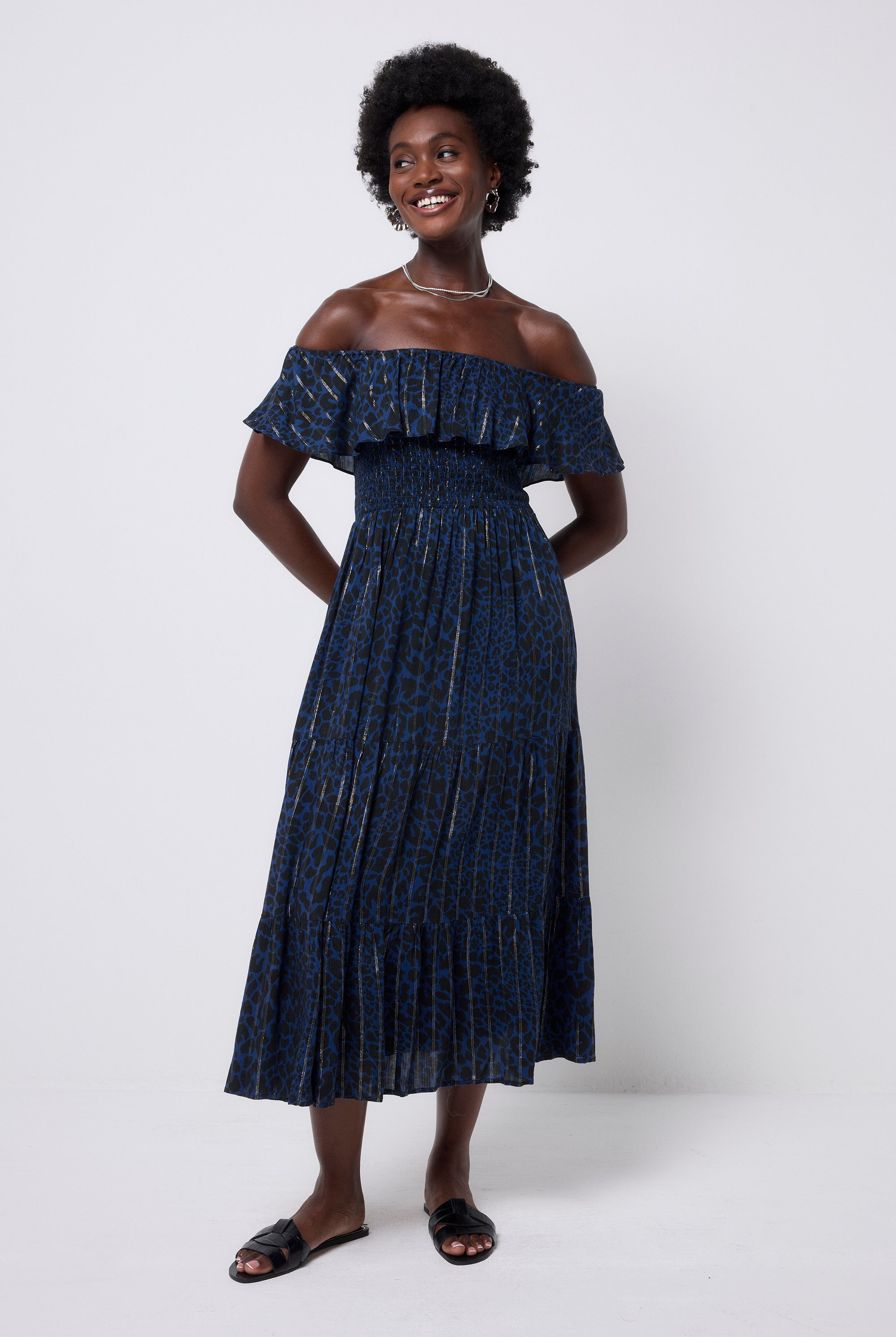 Scamp and Dude Navy with Black Rock and Roll Leopard Lurex Bardot Midi Dress  | Model wearing a dark navy bardot dress featuring black leopard print ad lurex stripe detail. Paired with black slip on sandals.