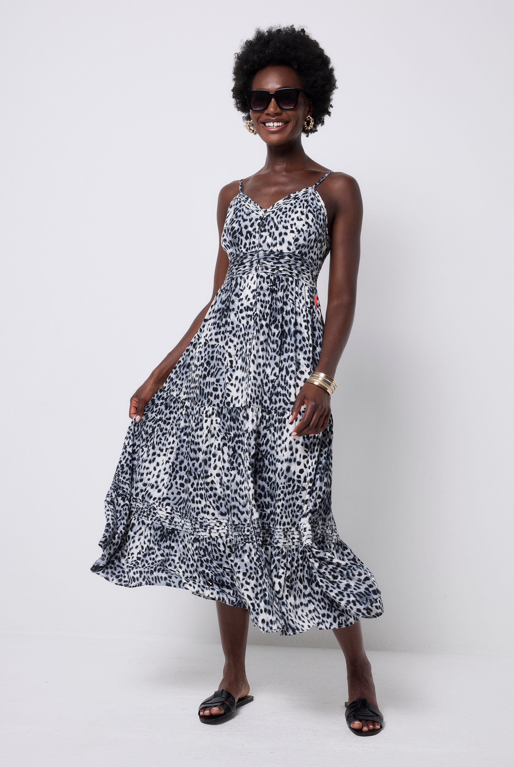 Scamp and Dude Grey with Black Cheetah Pintuck Midi Sundress | Model wearing a grey and white cheetah print sundress dress with black sunglasses and black sandals.