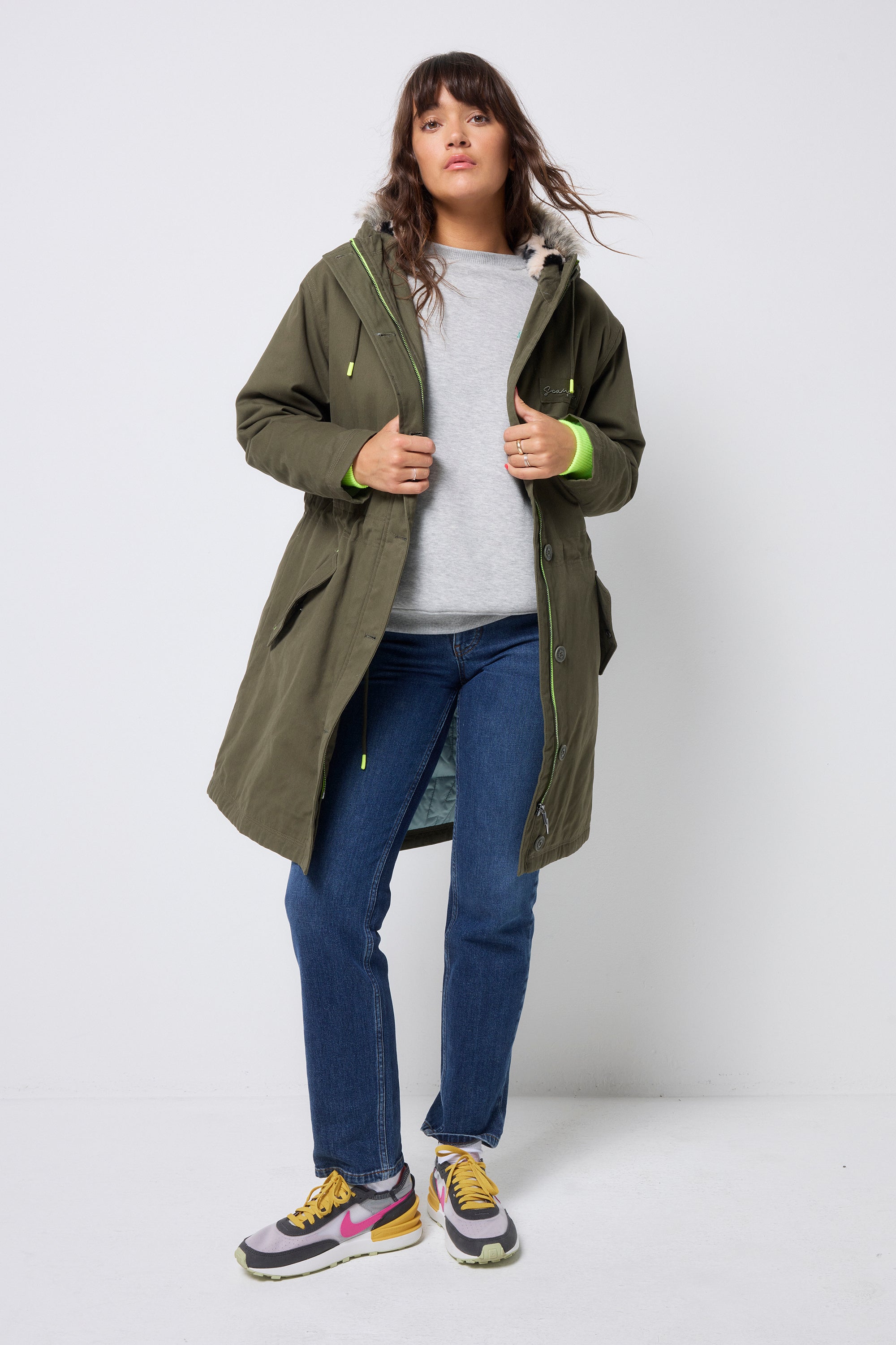 Scamp and Dude Khaki Parka | Model wearing a khaki parka jacket with blue jeans and a grey sweatshirt.