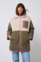 Scamp and Dude Quilted Khaki Lightning Bolt with Borg Coat | Model wearing khaki borg coat with grey love sweatshirt and distressed jeans.