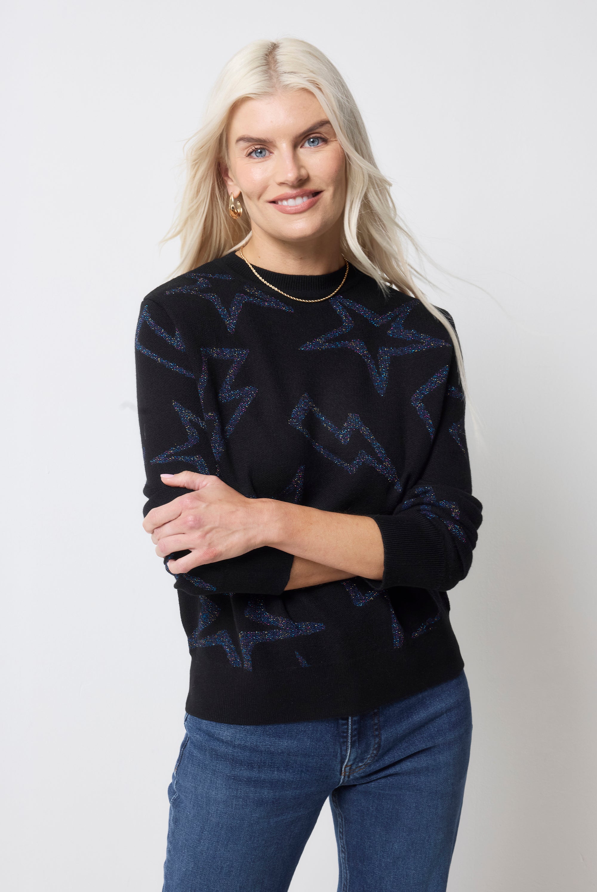 Scamp and Dude Black with Metallic Rainbow Star and Lightning Bolt Lurex Knit Jumper | Model wearing dark navy jumper with dark blue jeans.