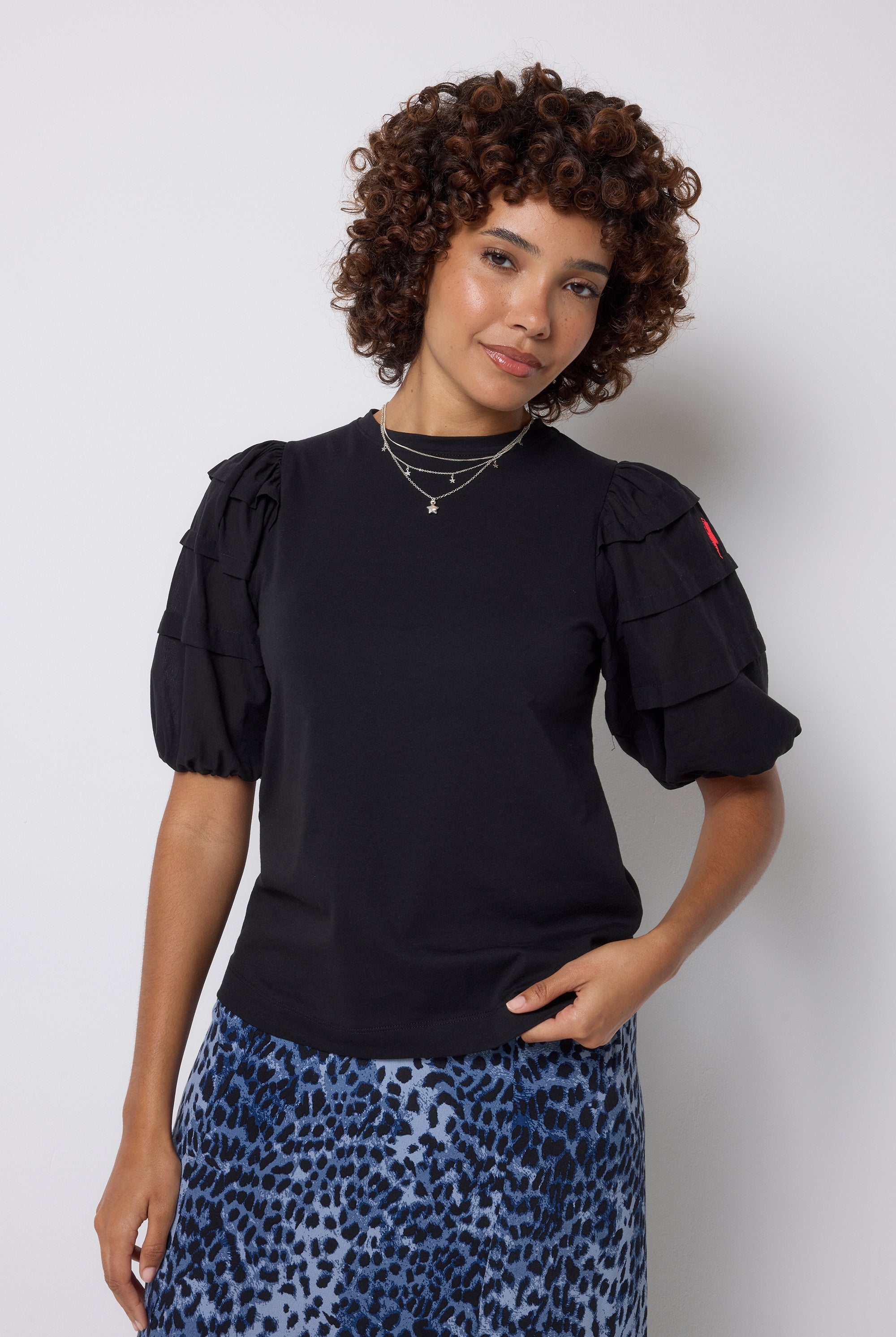 Scamp and Dude Black Pintuck Sleeve T-Shirt | Model wearing a navy cheetah print midi skirt with a black pintuck sleeve t shirt.
