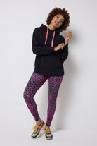 Scamp and Dude Grey with Pink Leopard Ray Full Length Active Leggings | Model wearing a black hoodie with grey and pink leopard ray print leggings.
