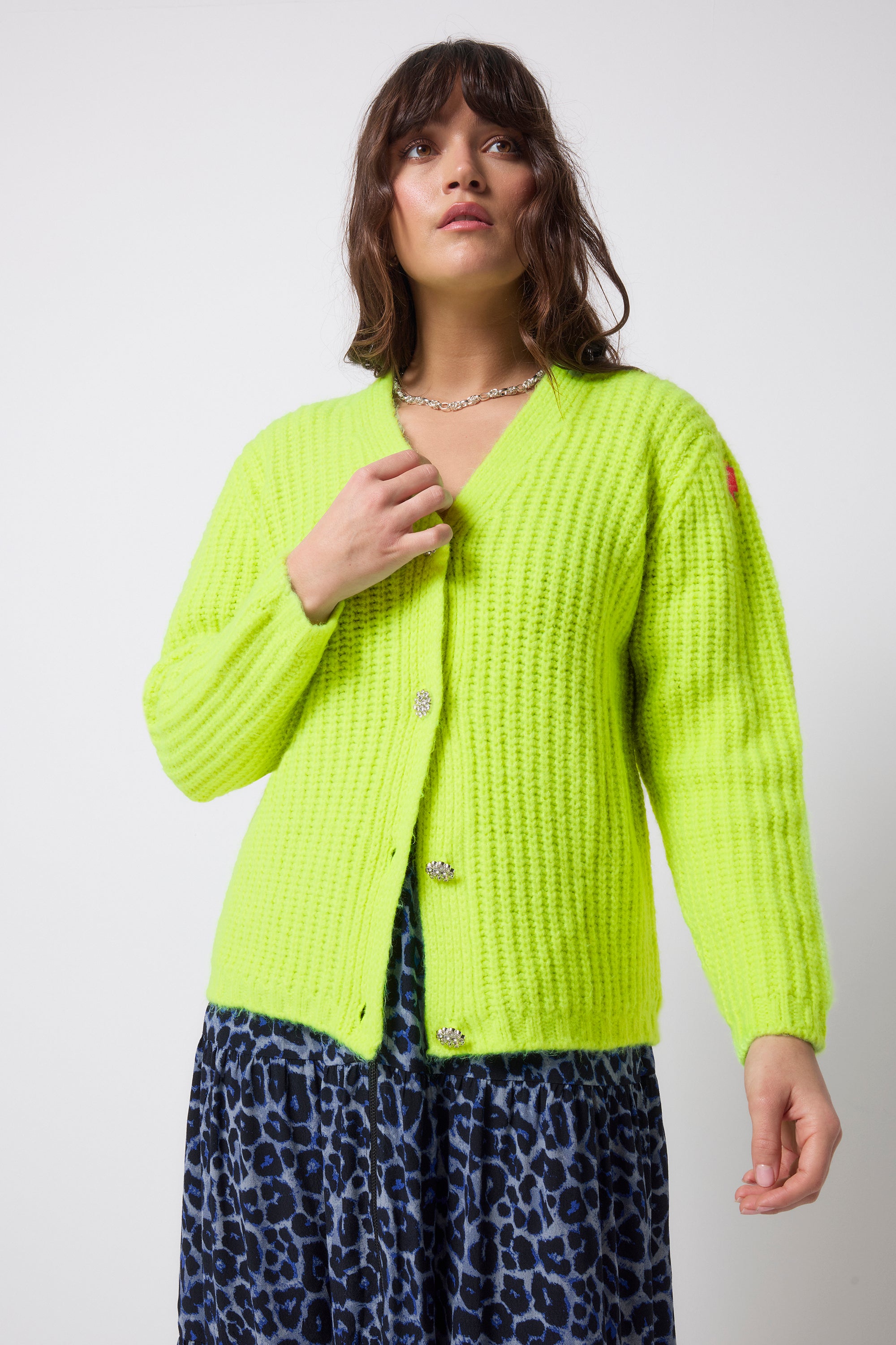 Scamp and Dude Neon Yellow Button Through Cardigan | Model wearing a navy jaguar zip front dress with a neon yellow cardigan that has diamante button detail.