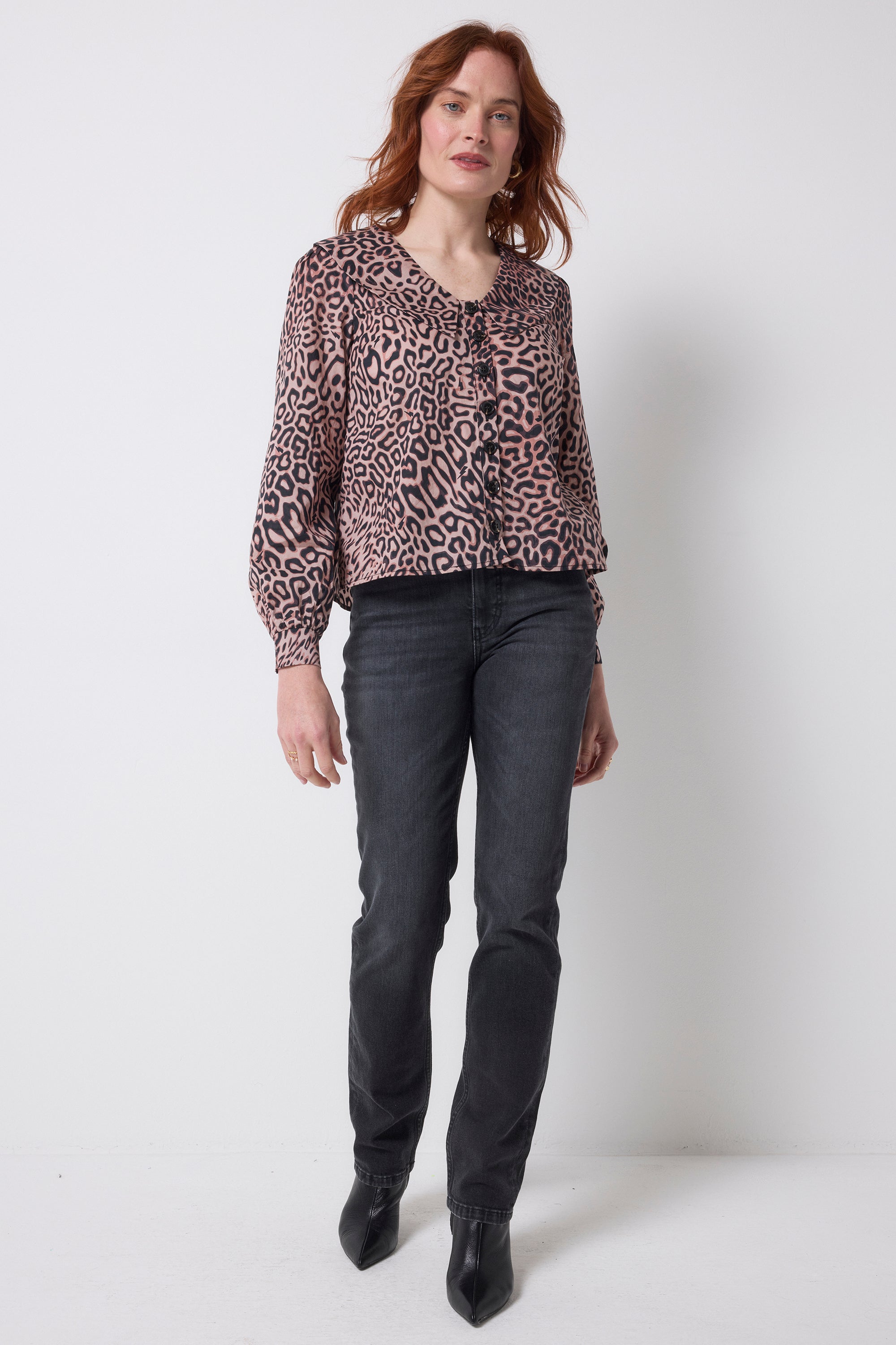 Scamp and Dude Neutral Leopard Ray Collared Blouse | Model wearing neutral leopard ray print blouse with washed black jeans and boots.