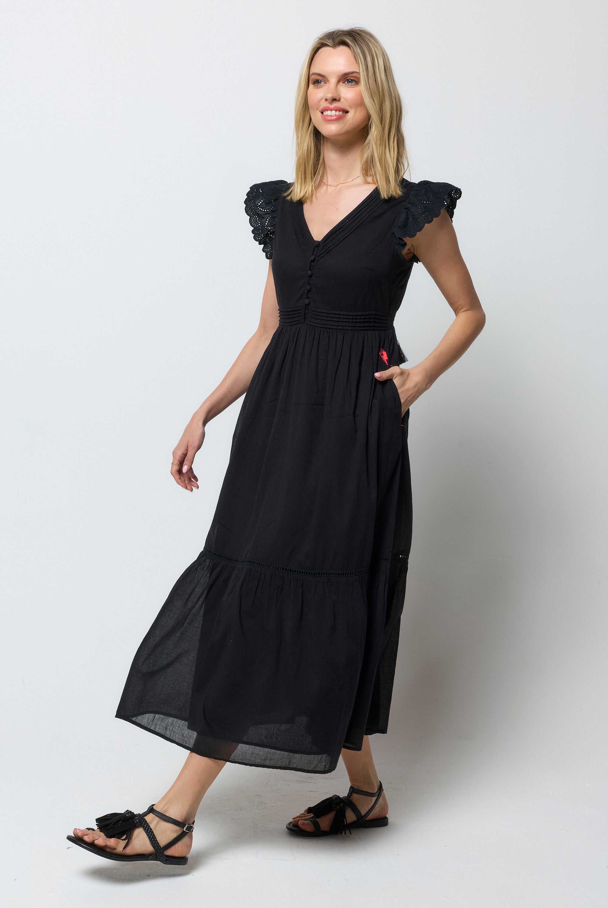 Scamp and Dude Black Broderie Sleeve Pintuck Midi Dress | Model wearing a black midi dress with broderie sleeve detail. Worn with black sandals.