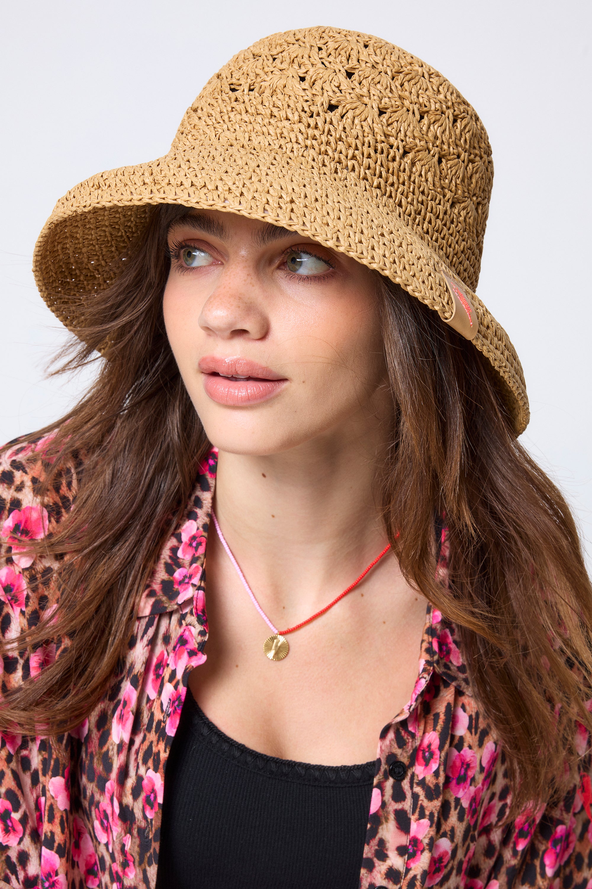 Scamp & Dude Natural Straw Bucket Hat | Model wearing a paradise cheetah print shirt with a straw bucket hat.