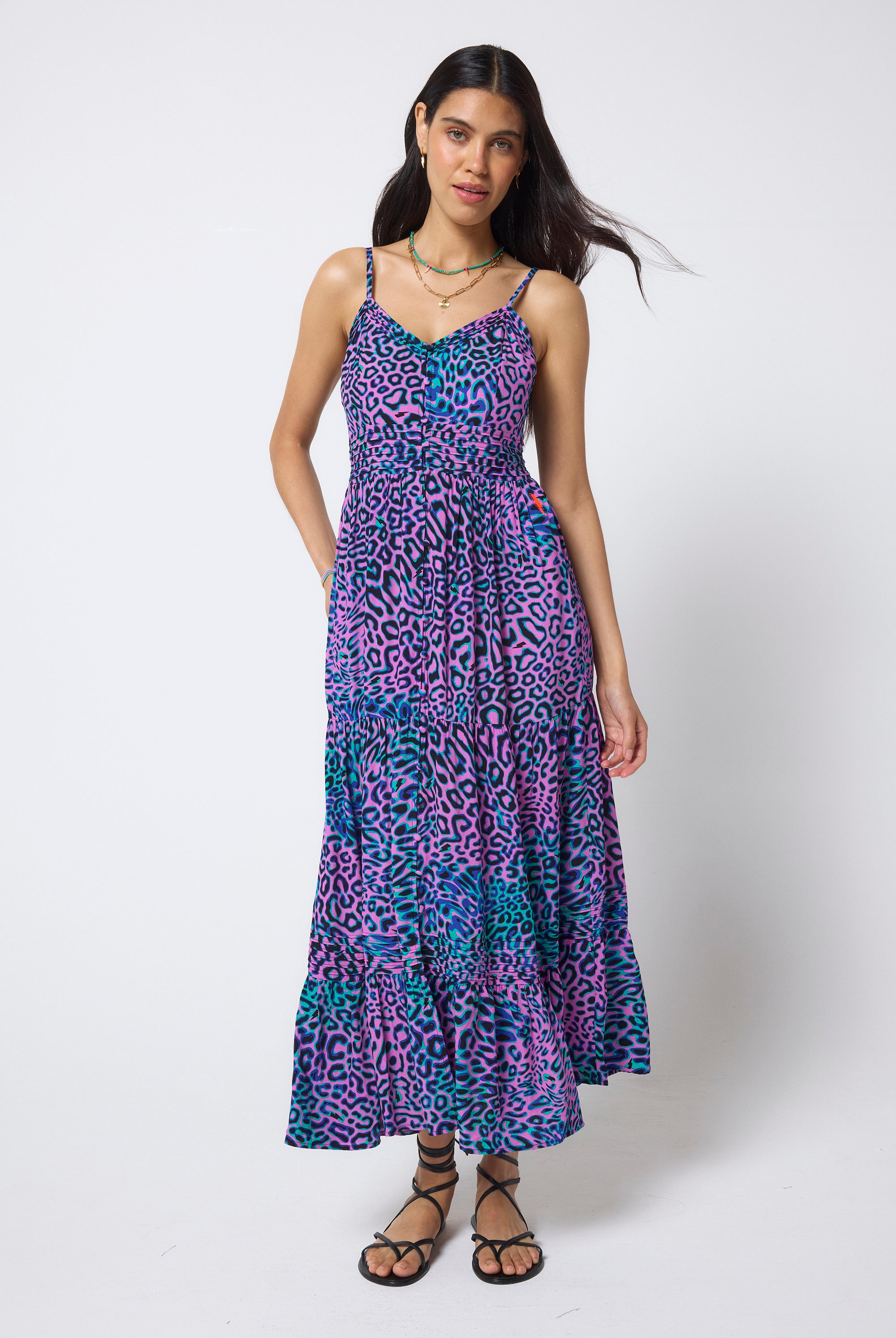 Scamp & Dude Pink with Green Leopard Ray Pintuck Midi Sundress | Model wearing a pink, purple and green patterned dress with black flat sandals.