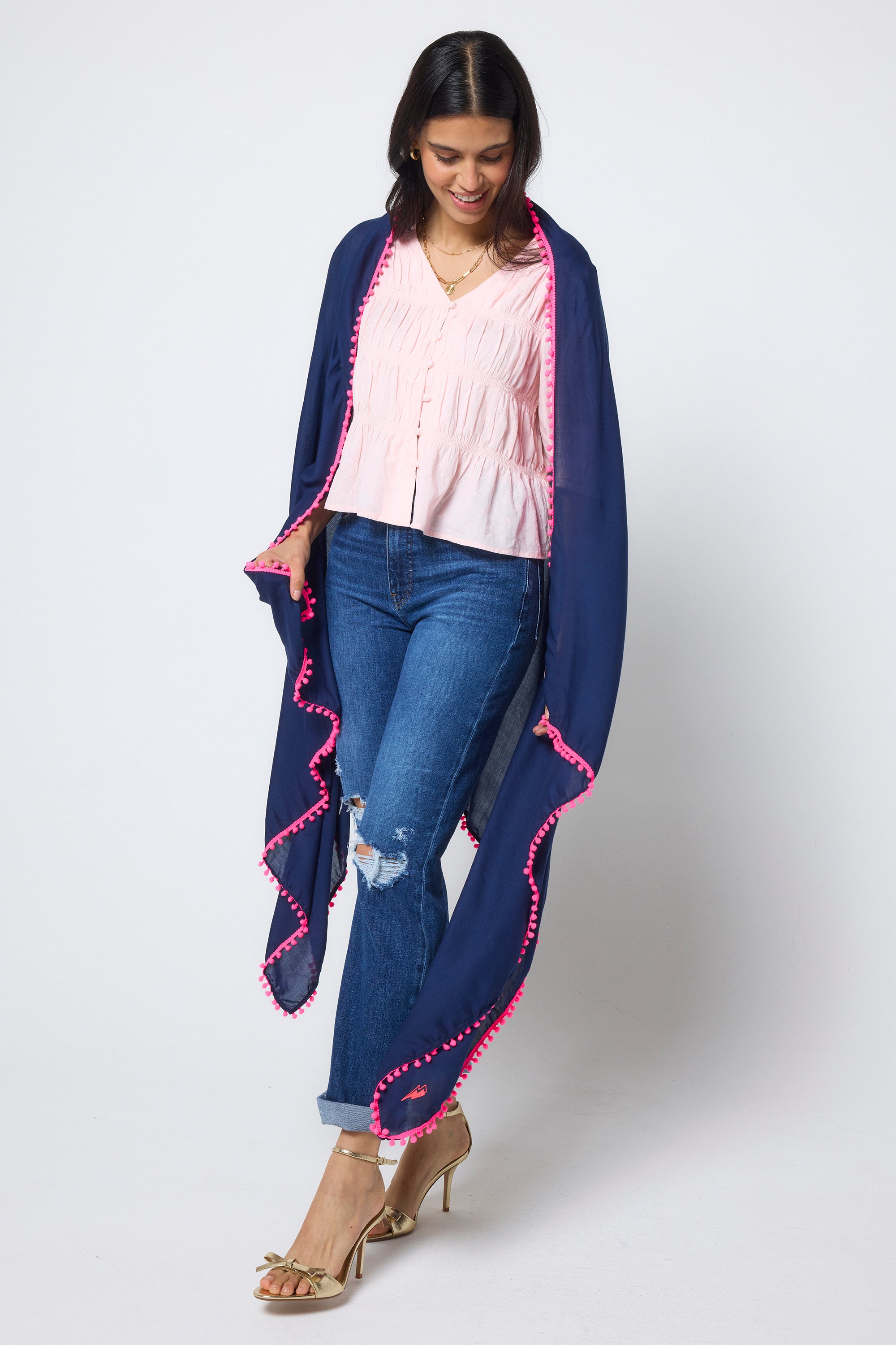 Scamp & Dude Navy Charity Super Scarf | Model wearing a pair of blue distressed jeans with a pink smocked top with a navy super scarf.