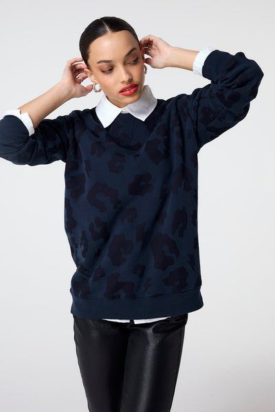 Scamp and Dude Navy with Navy Leopard Longline Sweatshirt | Model wearing dark navy leopard print sweatshirt in a longline fit, layered over a collared shirt.