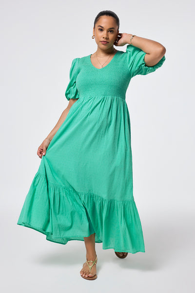 Scamp and Dude Mint Green Dobby Self Stripe Puff Sleeve Maxi Dress | Model wearing a mint green self stripe shirred puff sleeve maxi dress in a dobby finish paired with gold sandals.