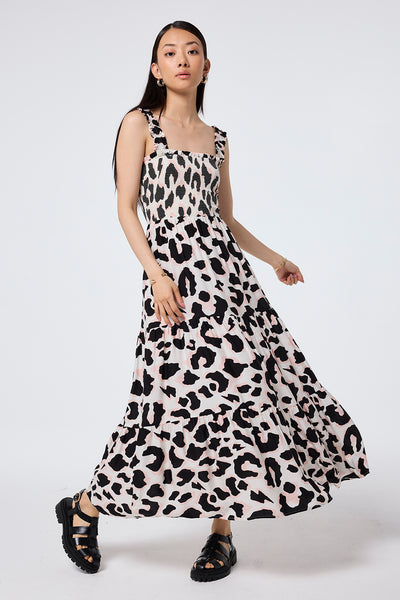 Scamp and Dude Ivory with Neutral and Black Mega Shadow Leopard Maxi Sundress | Model wearing an ivory maxi sundress with neutral and black mega shadow leopard print, featuring shirred bust and tiered skirt.