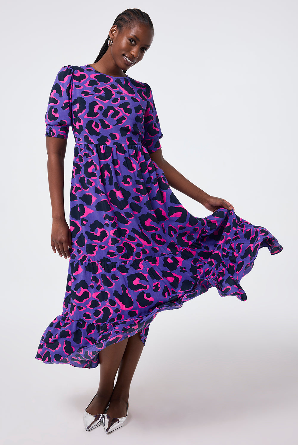 Scamp and Dude Purple with Pink and Black Snow Leopard Maxi Dress | Model wearing round neck purple maxi dress with a pink and black snow leopard print.