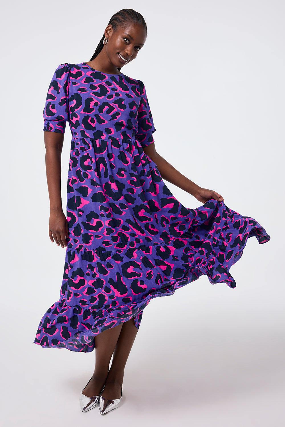 Scamp and Dude Purple with Pink and Black Snow Leopard Maxi Dress | Model wearing round neck purple maxi dress with a pink and black snow leopard print.
