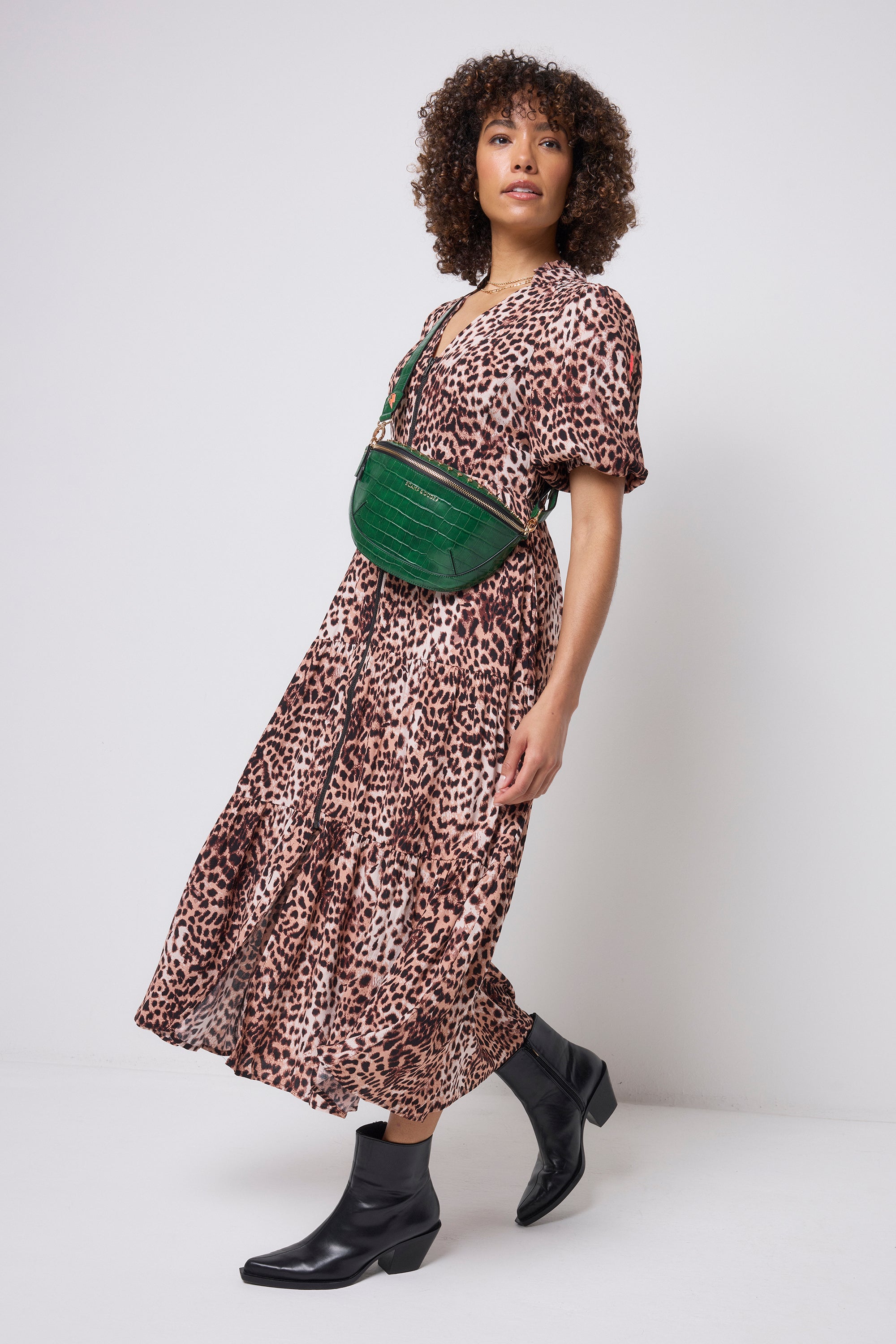 Scamp and Dude Green Embossed Croc Bum Bag | Model wearing a neutral cheetah print zip front dress with a green embossed croc bum bag.