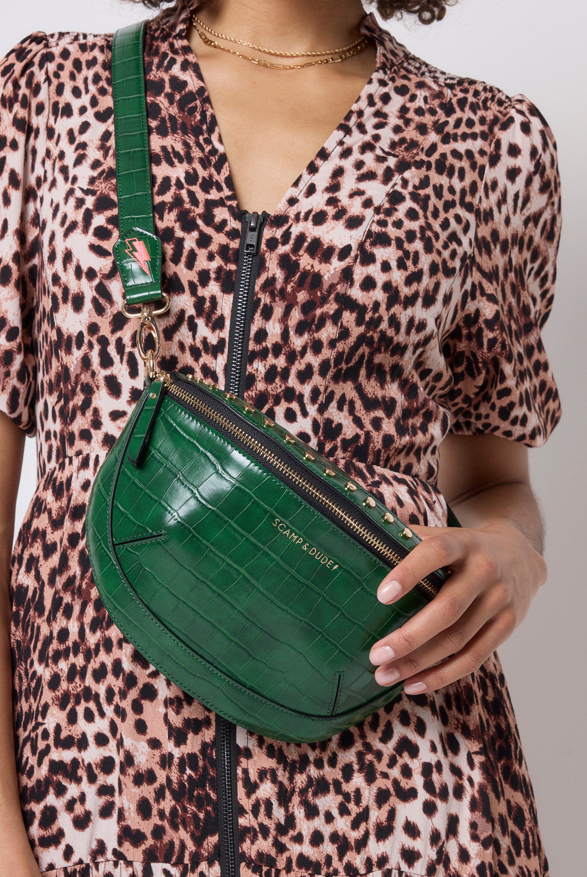 Scamp and Dude Green Embossed Croc Bum Bag | Model wearing a neutral cheetah print zip front dress with a green embossed croc bum bag.