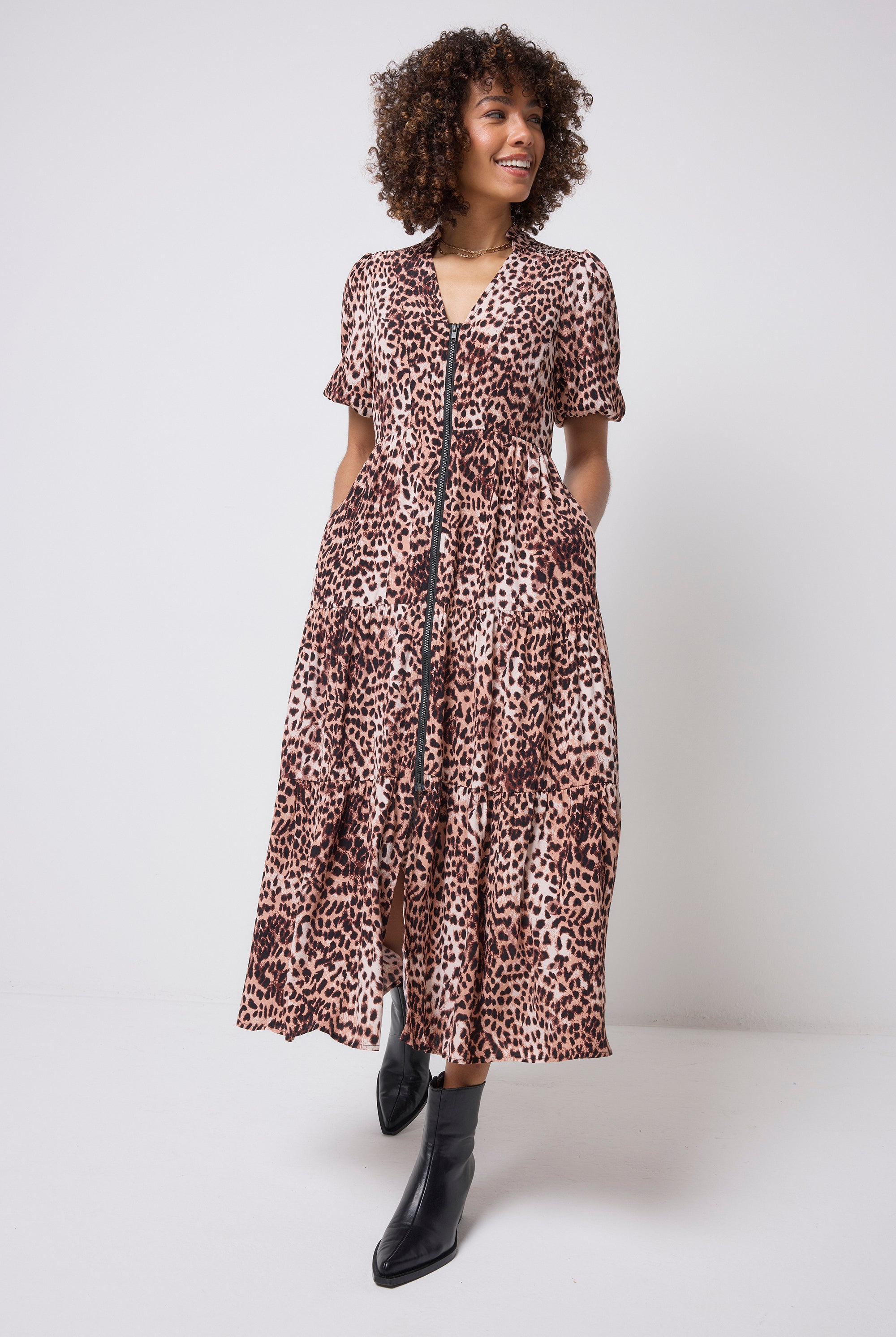 Scamp & Dude Neutral with Black Cheetah Zip Detail Tiered Midi Dress | Model wearing a neutral cheetah print zip through dress with black boots.