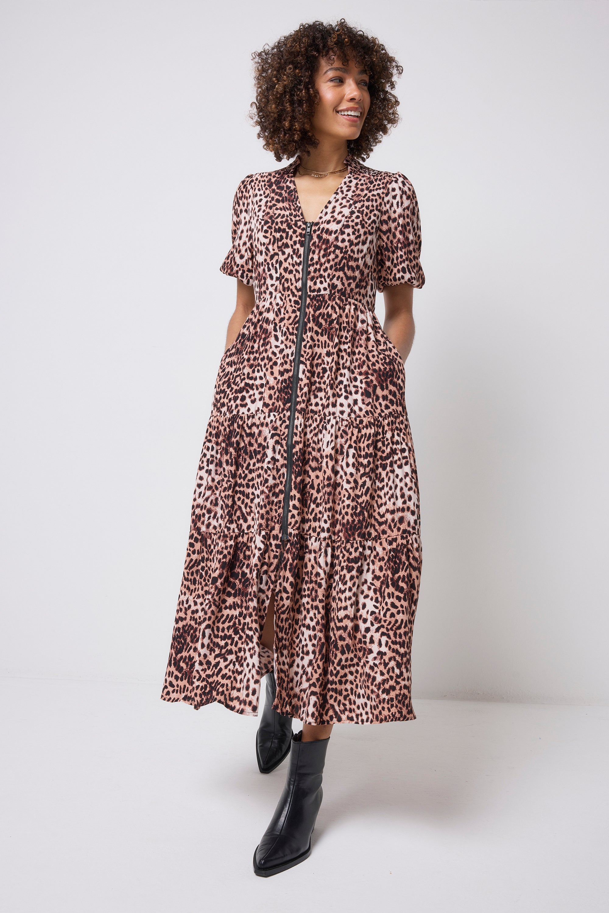 Scamp & Dude Neutral with Black Cheetah Zip Detail Tiered Midi Dress | Model wearing a neutral cheetah print zip through dress with black boots.