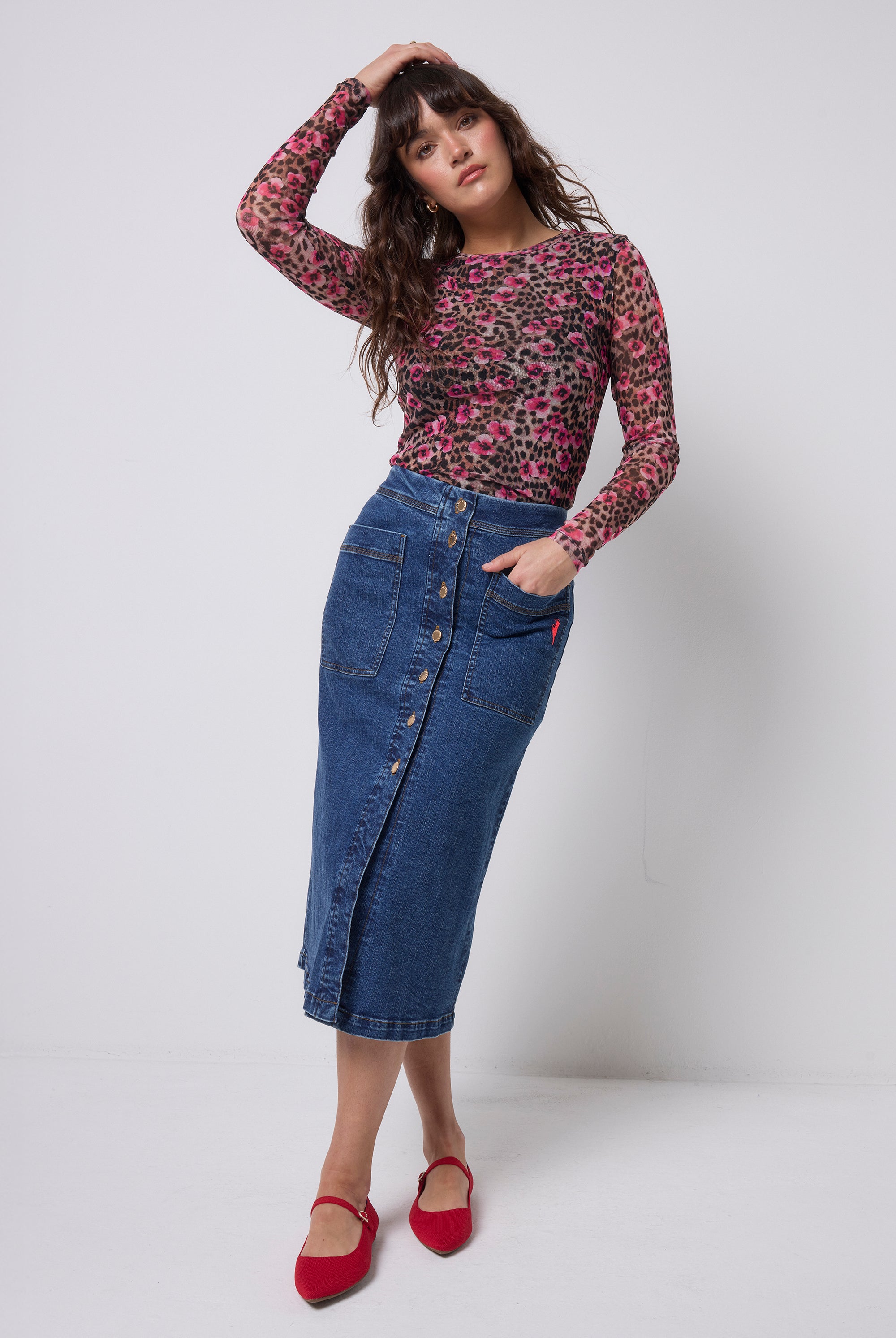 Scamp & Dude Neutral Paradise Cheetah Printed Mesh Top | Model wearing a floral cheetah print mesh top and dark blue button through denim skirt.