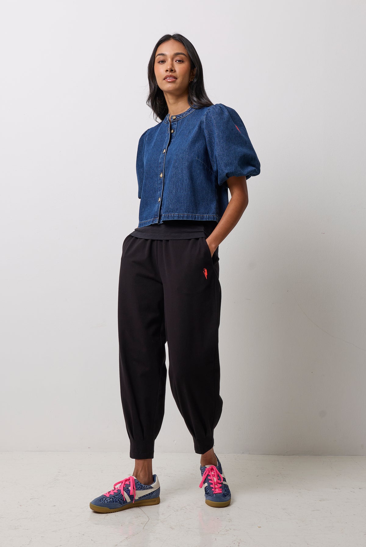 Scamp & Dude Indigo Boxy Puff Sleeve Denim Jacket | Model wearing a cropped blue denim jacket with puff sleeves and black jogger pants.