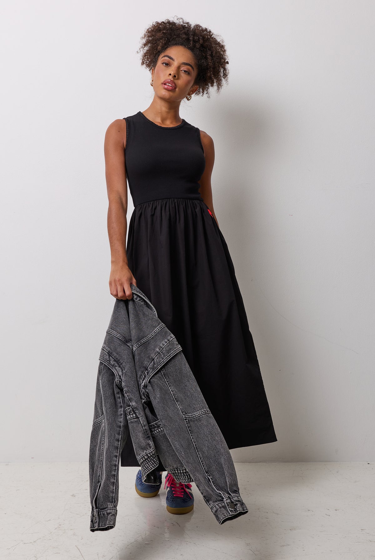 Scamp & Dude Black Jersey Woven Mix Midi Dress | Model wearing a black midi dress with a black denim jacket.