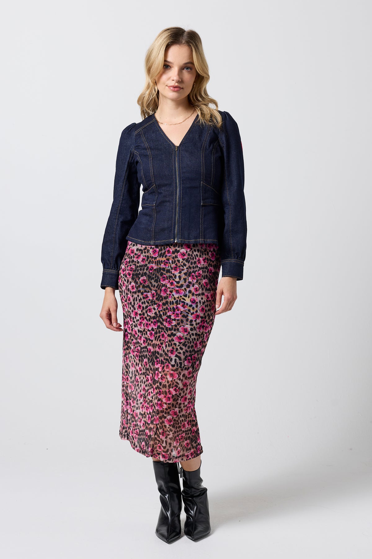 Scamp & Dude Rinse Wash Long Sleeve Seamed Denim Top | Model wearing a long sleeve denim top with a paradise cheetah mesh dress underneath. Worn with heeled black boots.