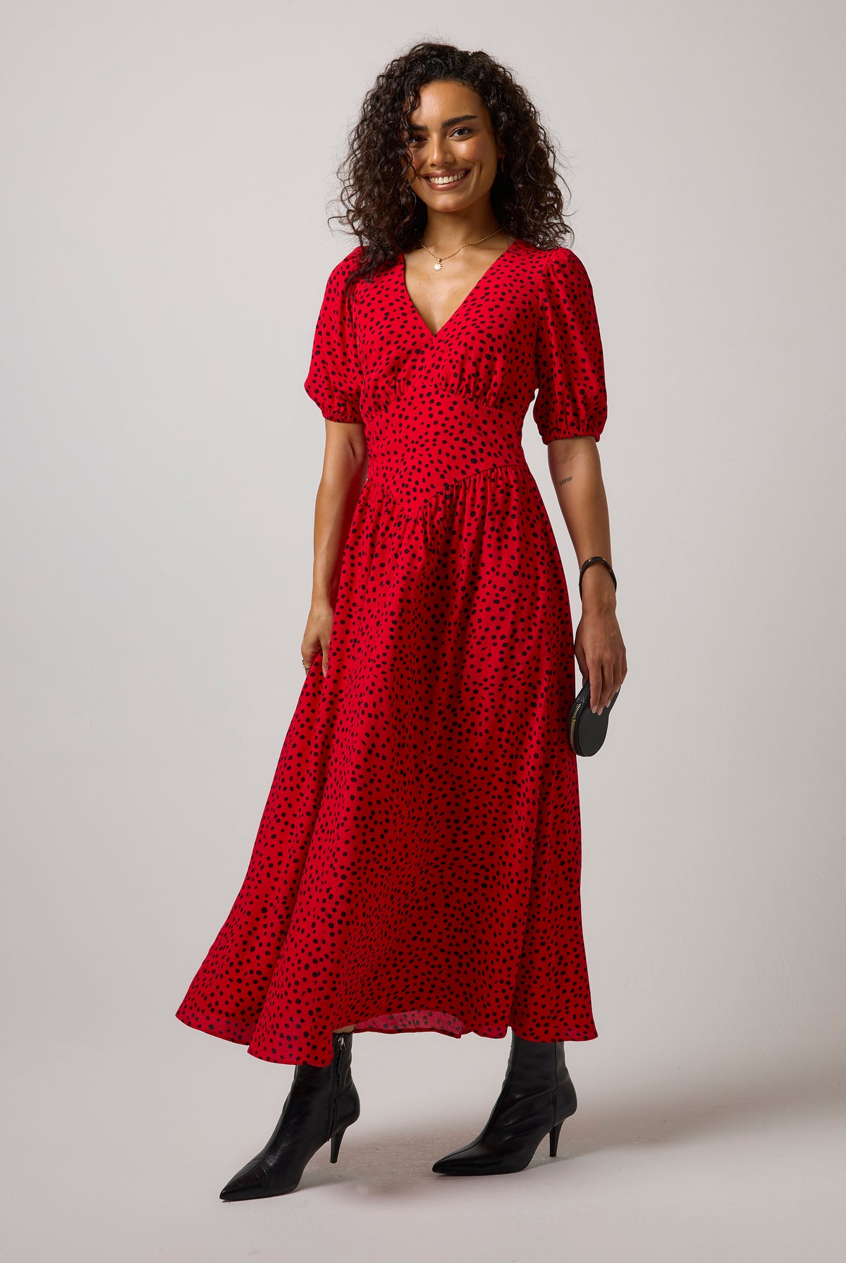 Scamp & Dude Red with Black Cheetah Spot Drop Waist Midi Dress | Model wearing a red animal print midi with a pair of black boots.