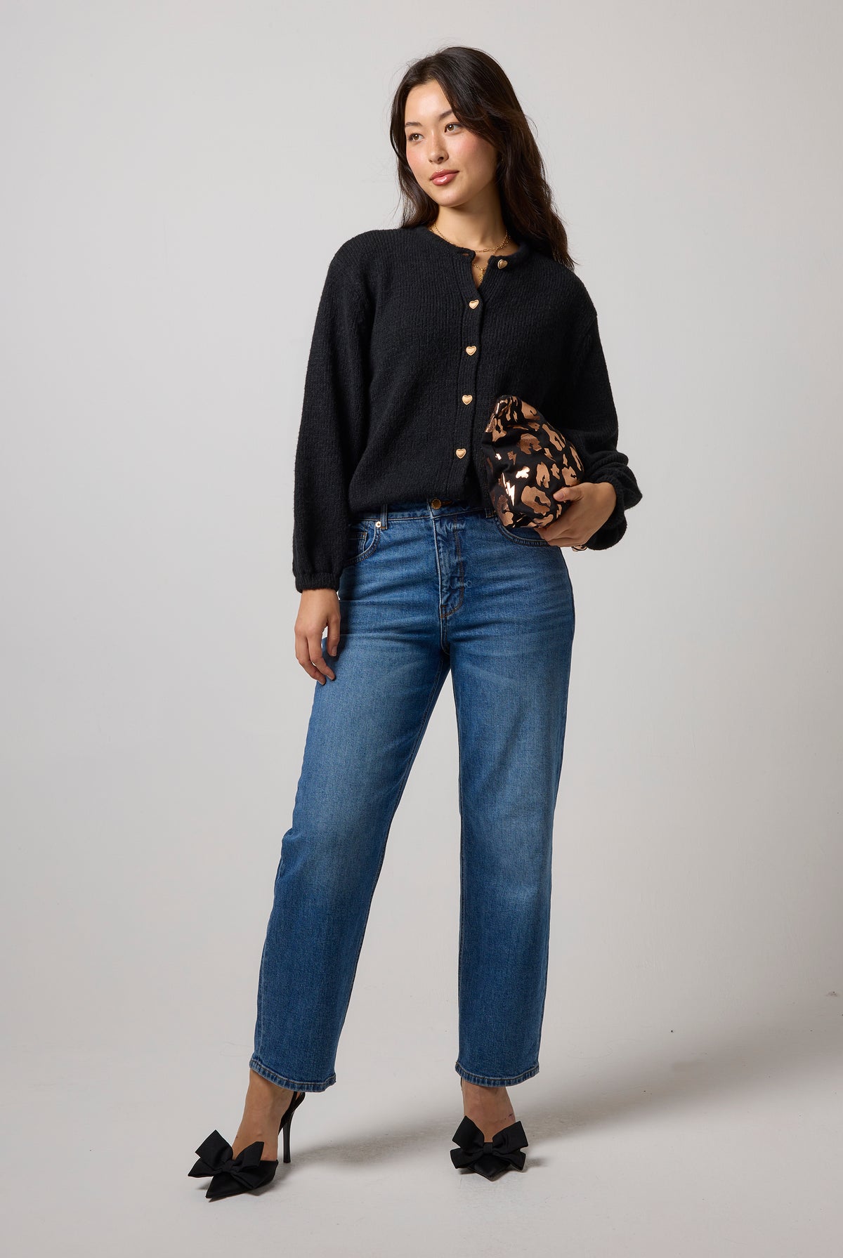 Scamp & Dude Black Long Sleeve Cardigan | Model wearing long sleeve black cardigan with a pair of blue jeans.