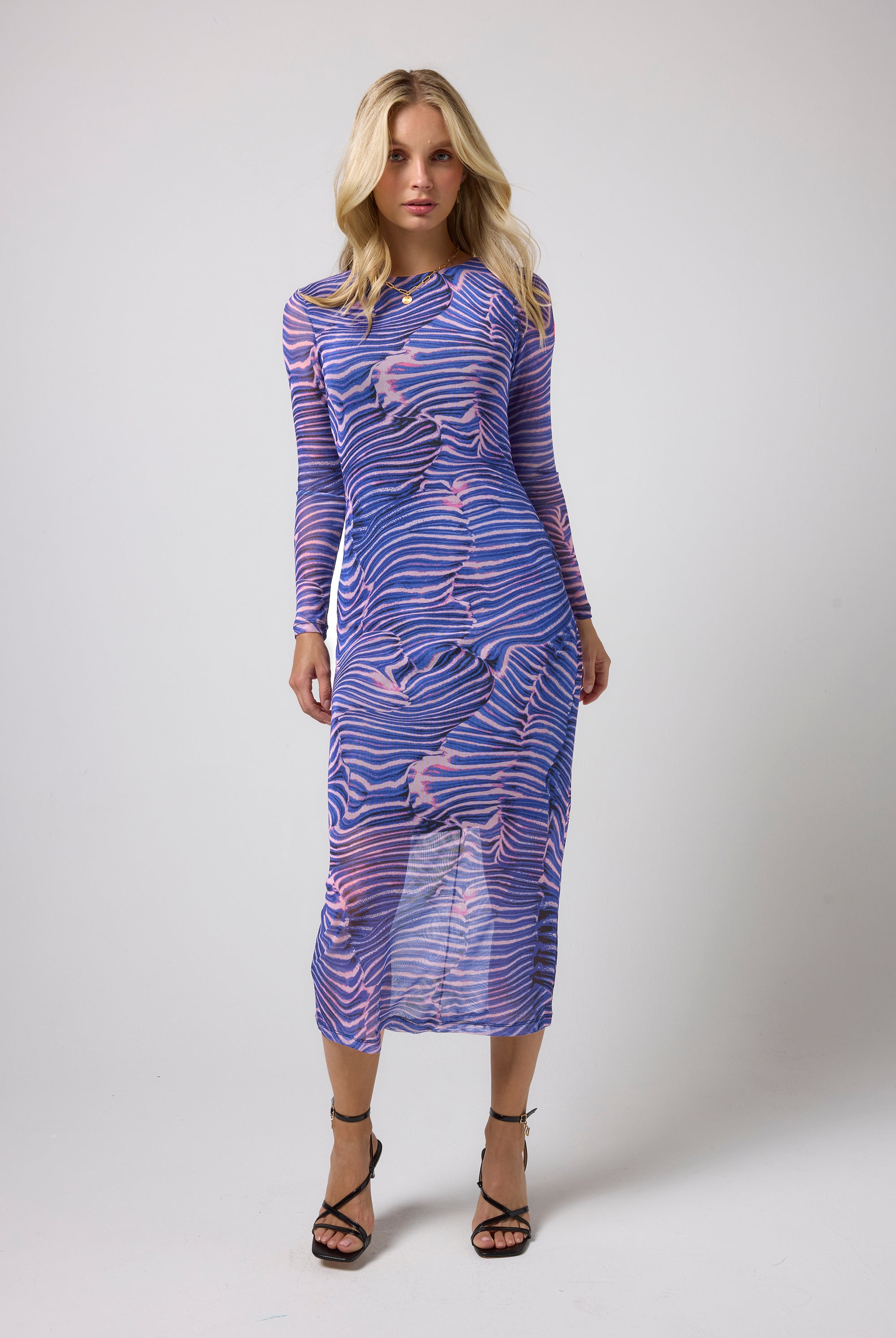 Scamp & Dude Blue Tiger Moth Mesh Midi Dress | Model wearing a mesh midi dress in a tiger moth print with black strappy heels.