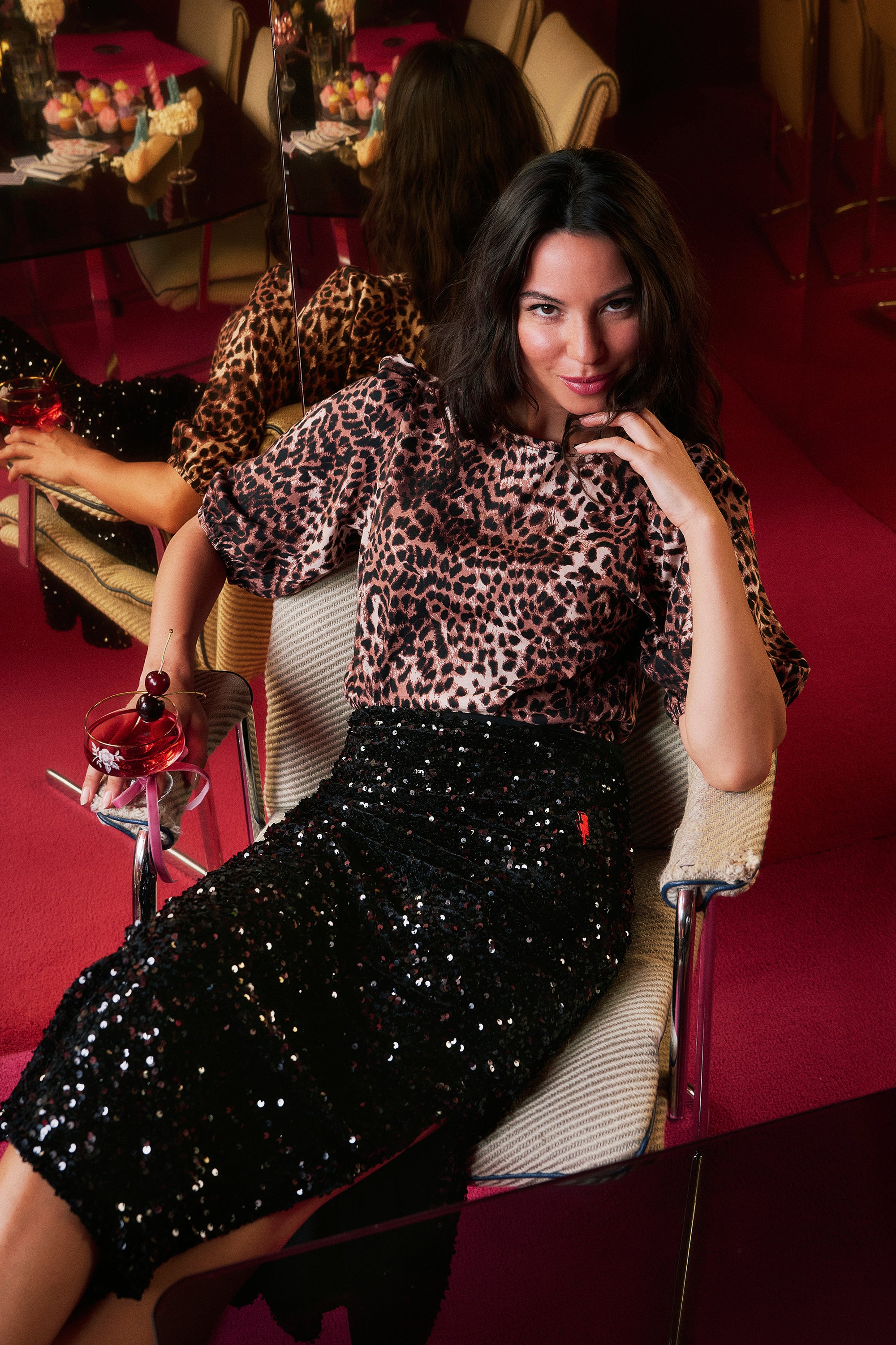 Scamp and Dude Black Sequin Velvet Midi Skirt | Model wearing a black sequin midi skirt with a neutral cheetah t-shirt.