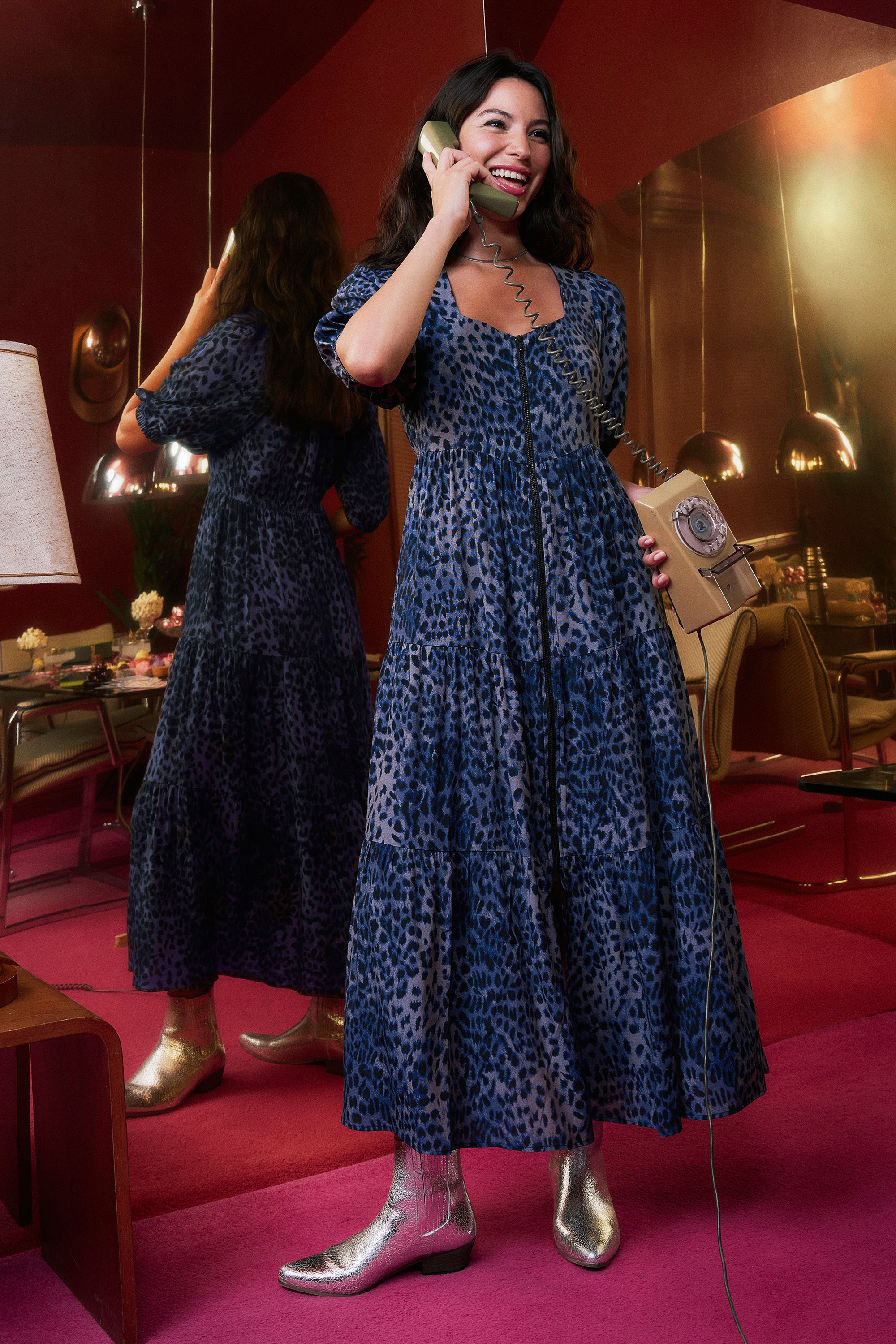 Scamp and Dude Navy Cheetah Square Neck Zip Detail Tiered Midi Dress | Model wearing a square neck zip front dress in a navy blue cheetah print. Worn with silver boots.