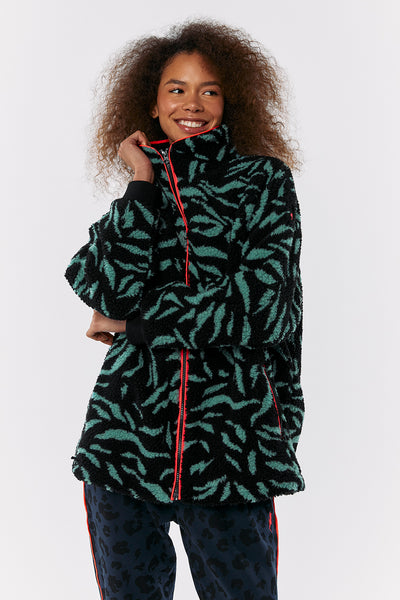 Scamp and Dude Black with Khaki Zebra Fleece Jacket | Model wearing black fluffy fleece with green zebra print and black trousers