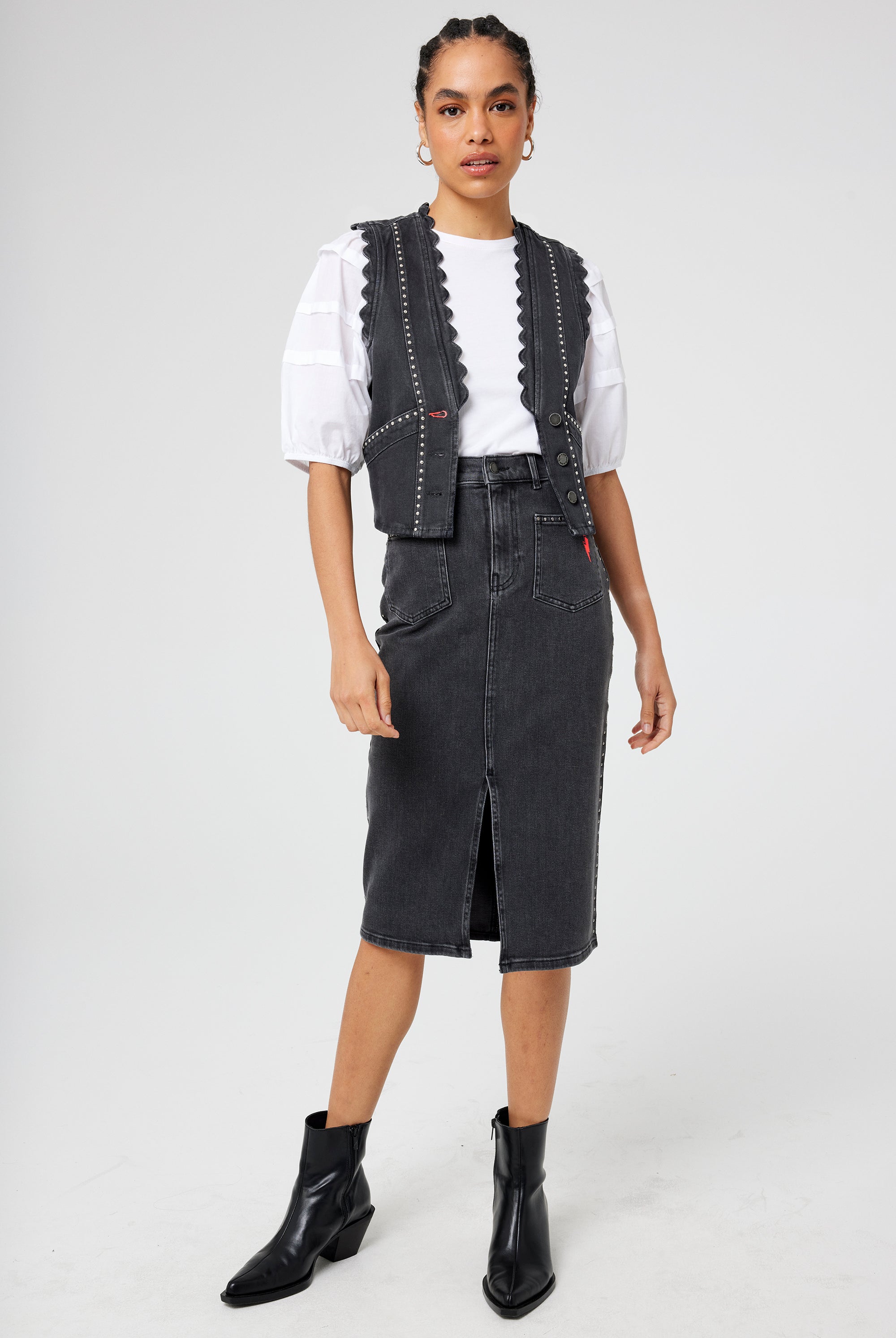 Scamp and Dude Washed Black Studded Denim Scallop Waistcoat | Model wearing washed black denim skirt and waistcoat over a white t shirt.