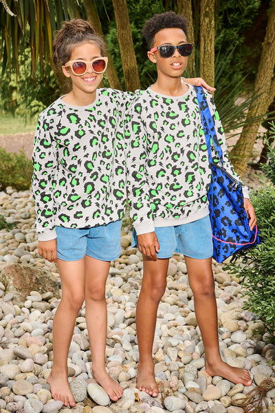 Scamp and Dude Grey and Green Leopard Print Long Sleeve Top | Two children wearing matching leopard green and black print with blue shorts