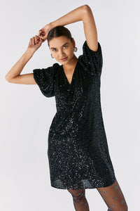 Scamp and Dude Black Sequin Short T-Shirt Dress | Model with hands above head wearing a black sequin short dress 